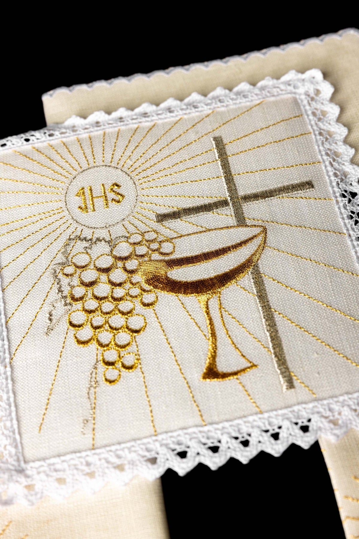 Altar linen set close-up showing gold chalice, cross and grape embroidery with lace trim
