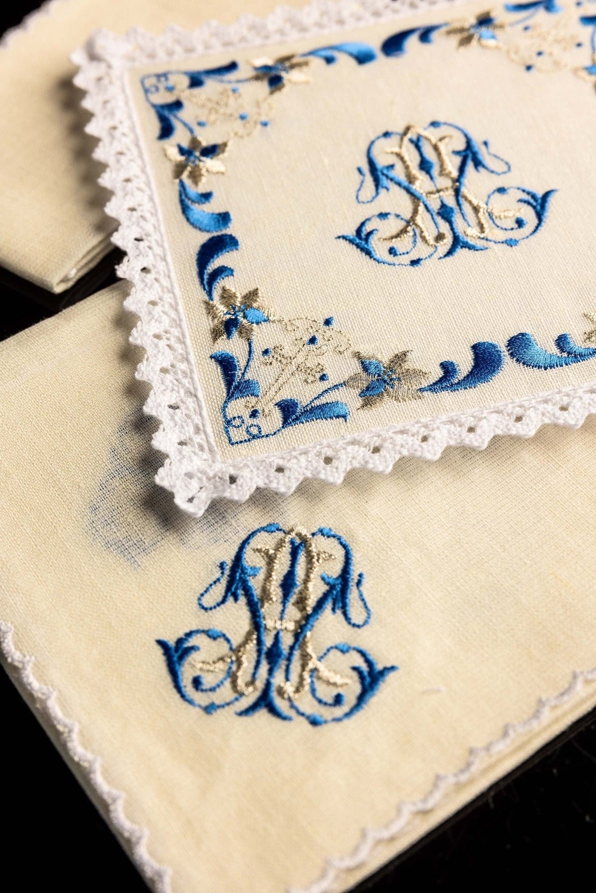 Altar linen set close-up showing blue and gold Marian embroidery with lace trim