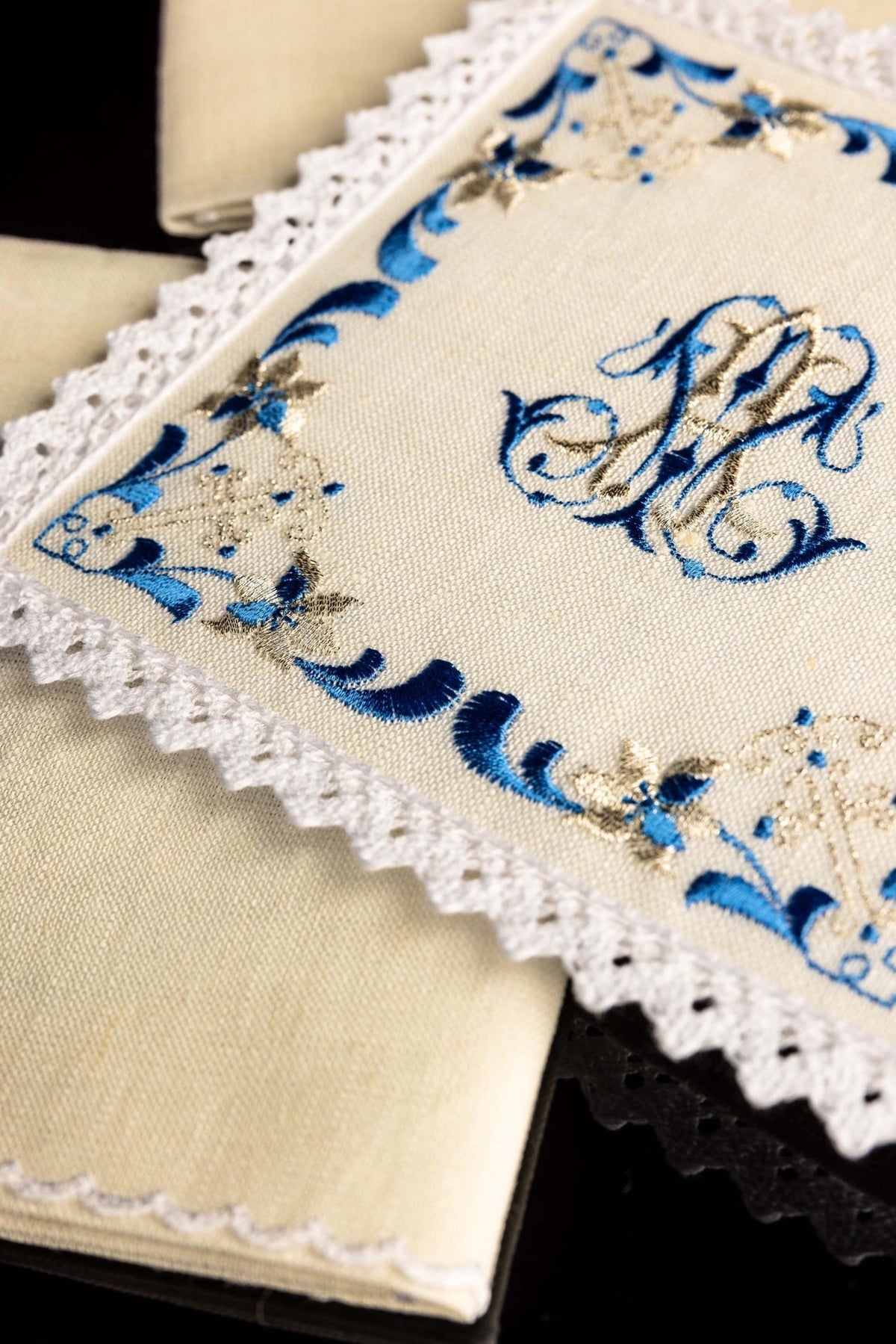Altar linen set close-up of blue and gold embroidery and scalloped lace edging
