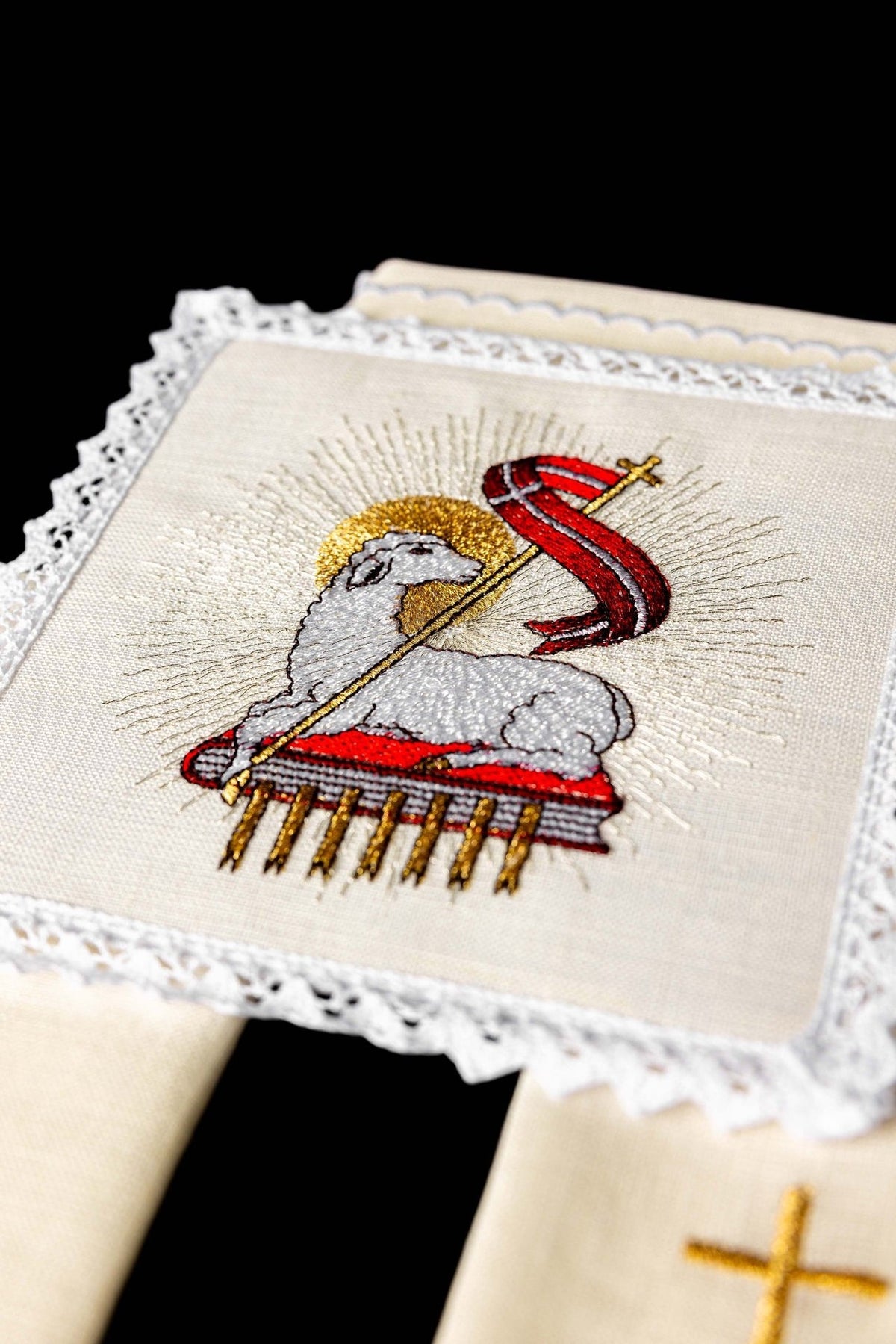 Altar linen set close-up of embroidered Agnus Dei motif with lace border