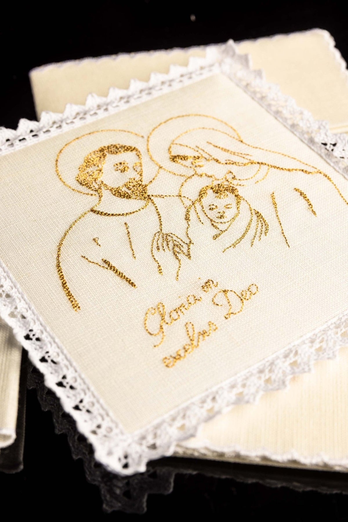 Altar linen set close-up showing gold embroidered Holy Family motif and lace trim