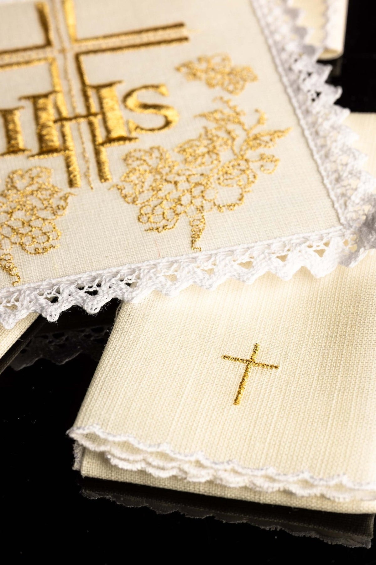 Altar linen set detail showing gold grape embroidery, lace trim and small cross