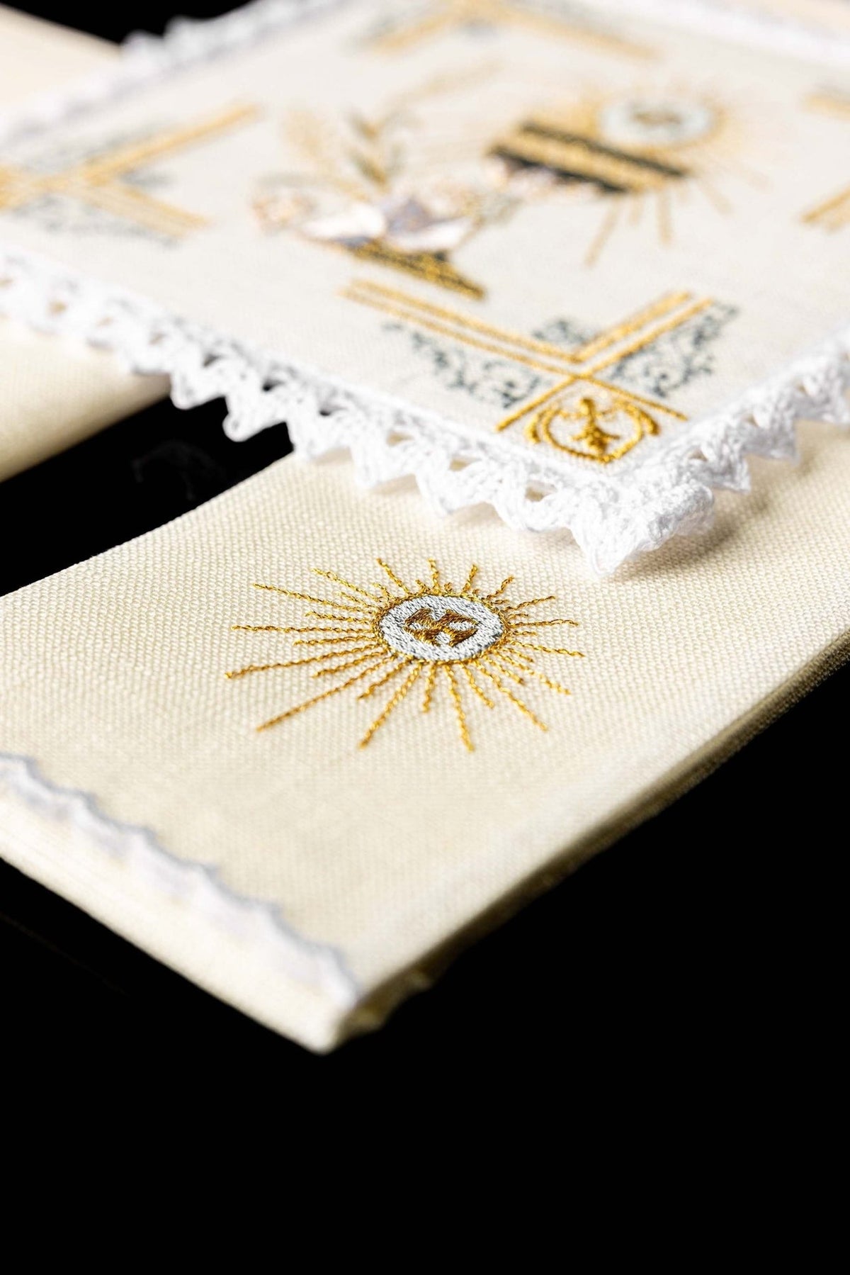 Altar linen set detail with gold embroidered Eucharistic sunburst on linen