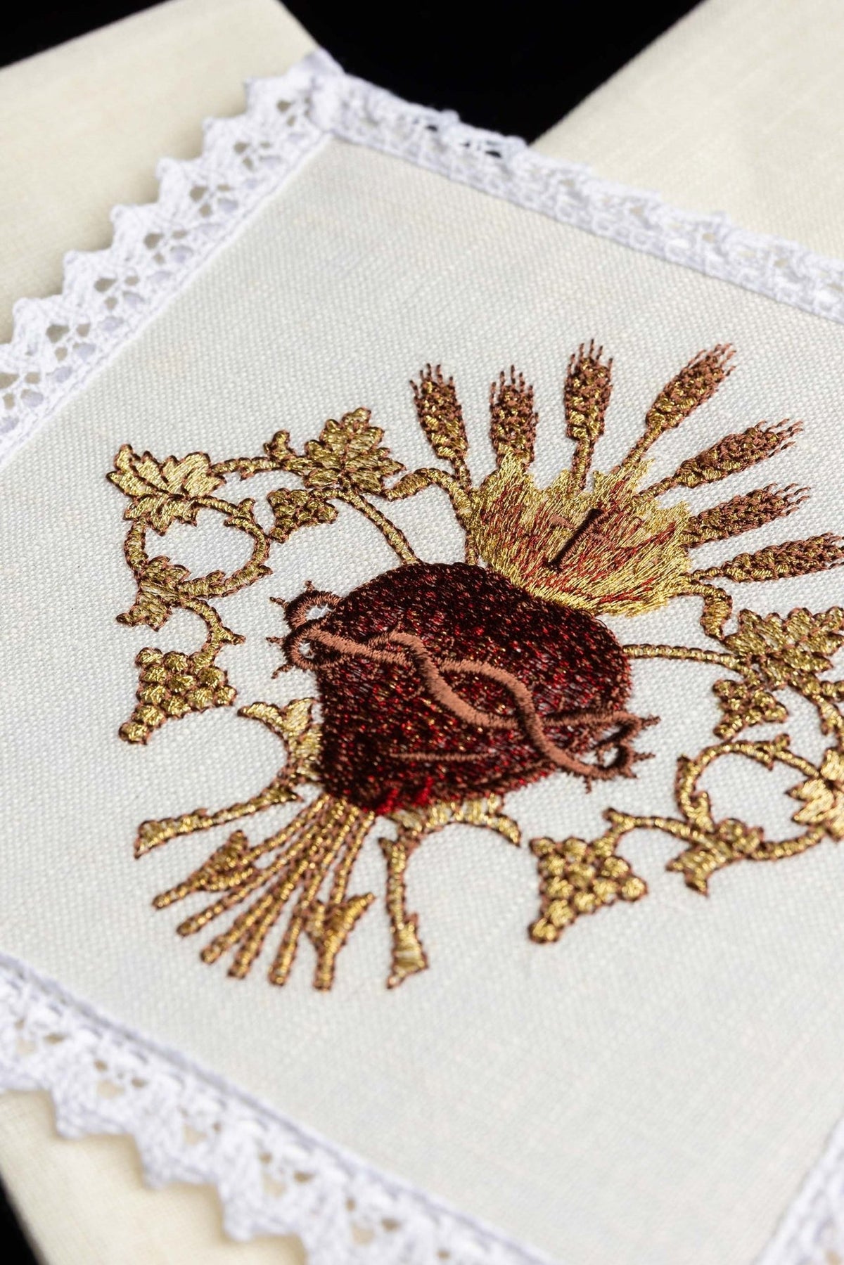 Altar linen set close-up showing the embroidered Sacred Heart of Jesus with wheat and vine motifs