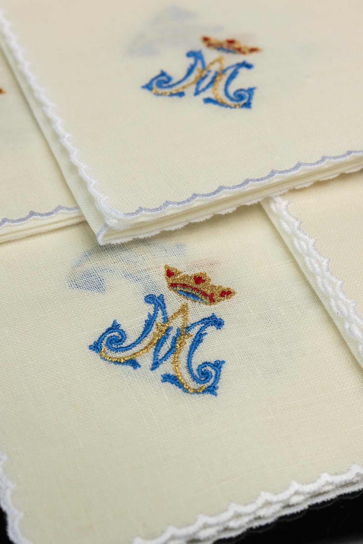 Linen corporals close-up with Marian motif, scalloped white edging and blue and gold embroidery