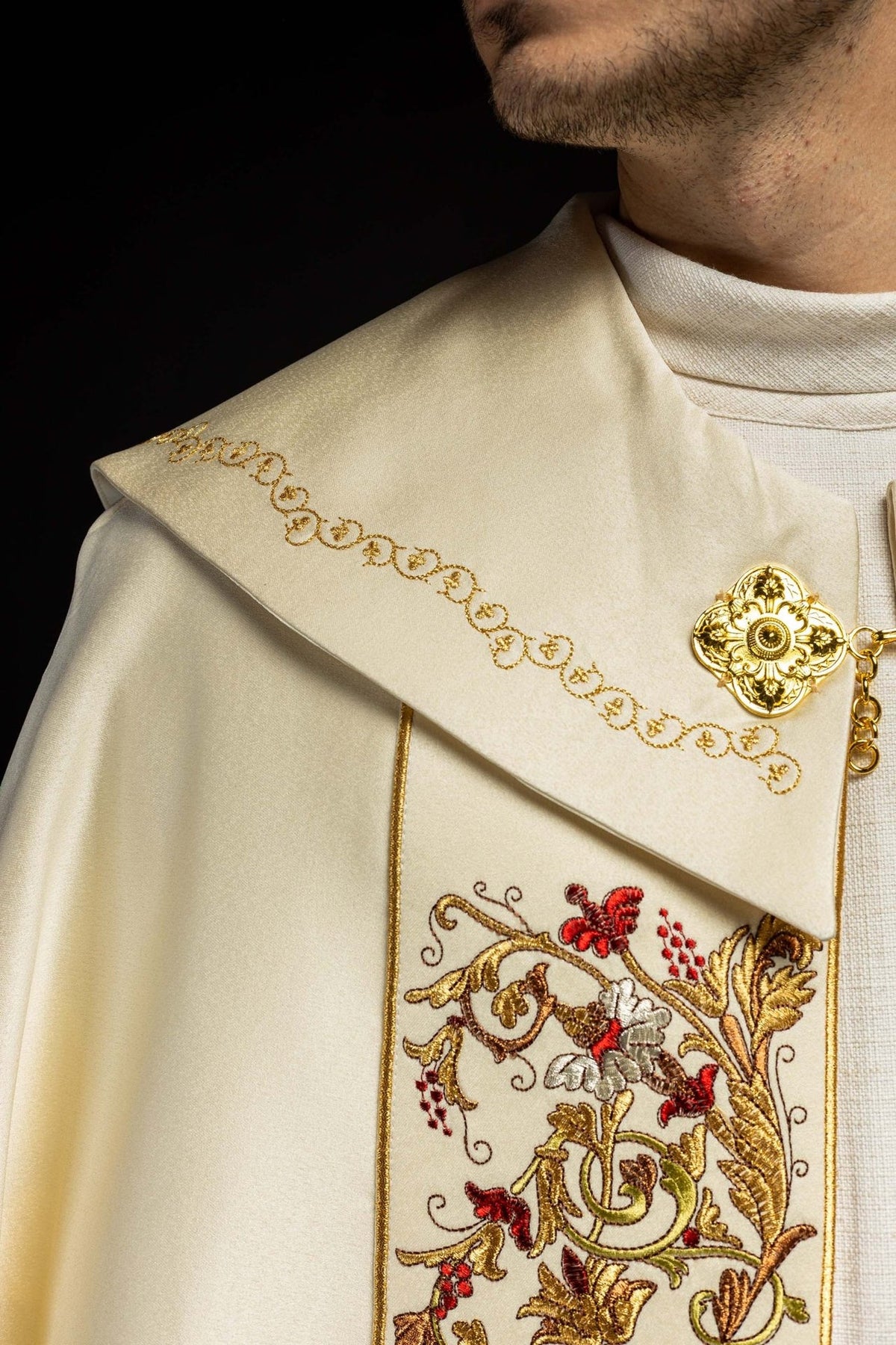 Ecru satin cope, side close-up with gold embroidered border and floral panel