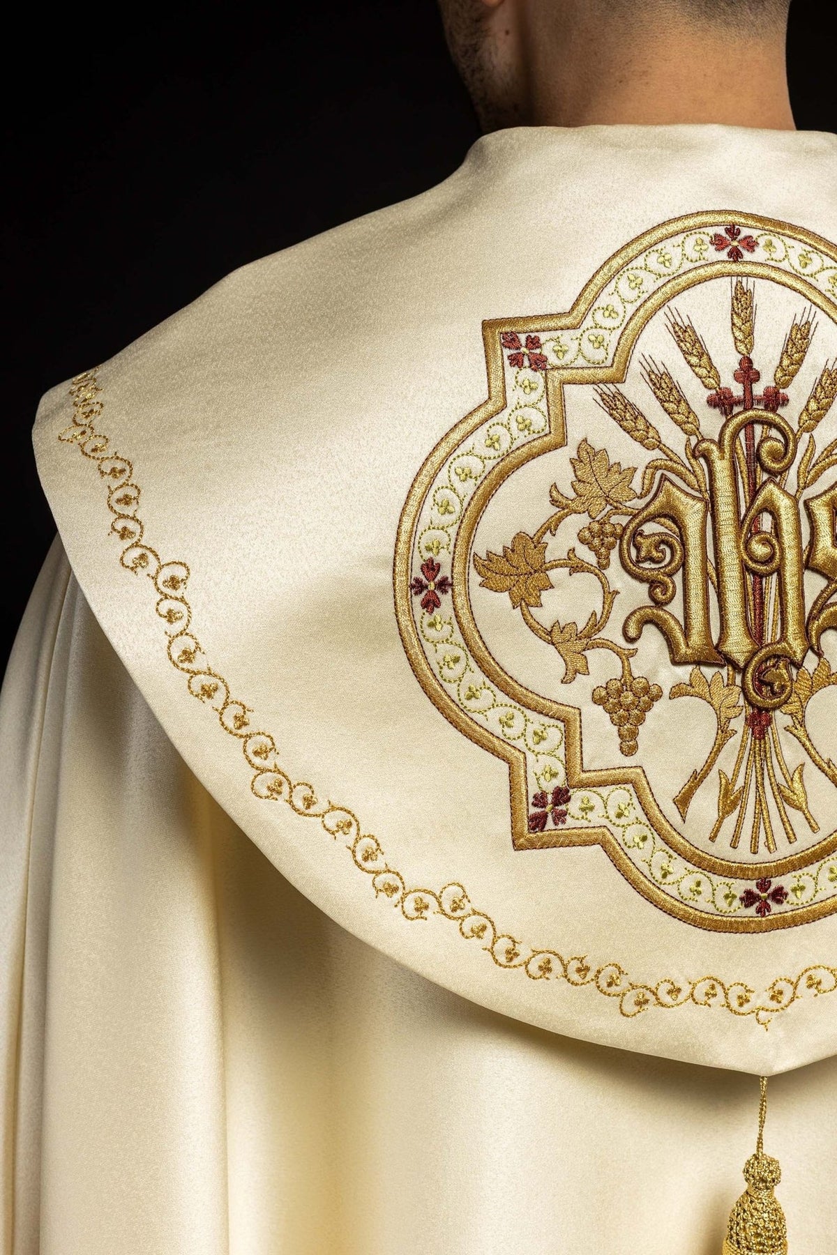 Ecru satin cope, back detail with gold embroidered border and tassel