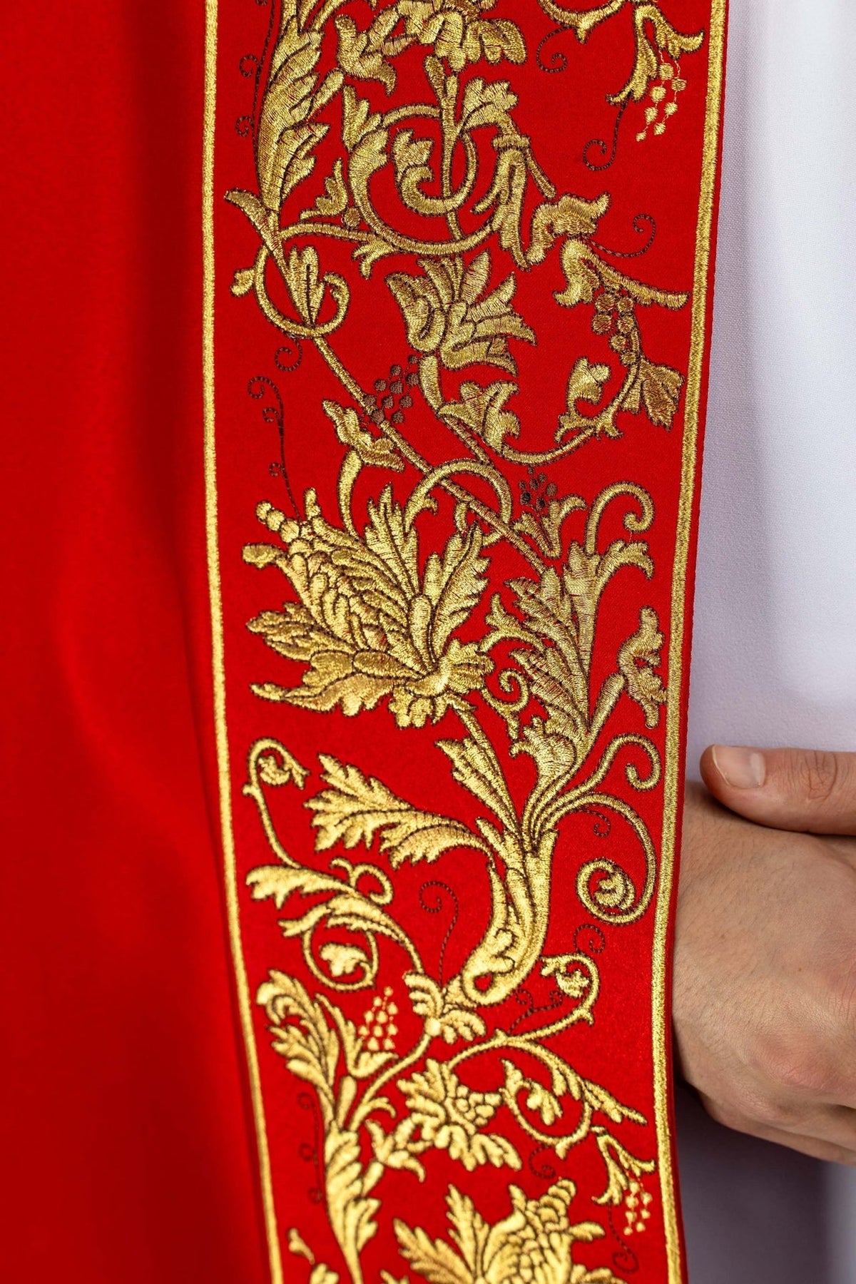 Red liturgical cope close-up of embroidered gold floral orphrey