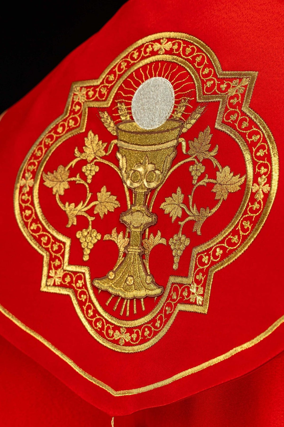 Red liturgical cope close-up of gold fastening and trim