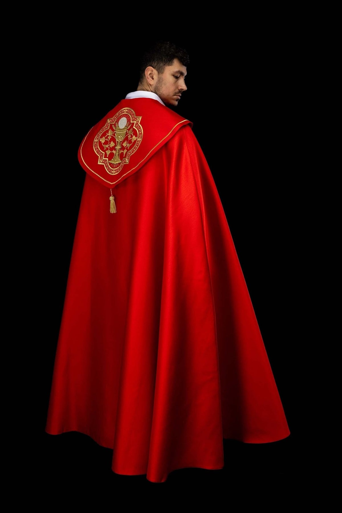 Red liturgical cope back detail with gold trim and tassel
