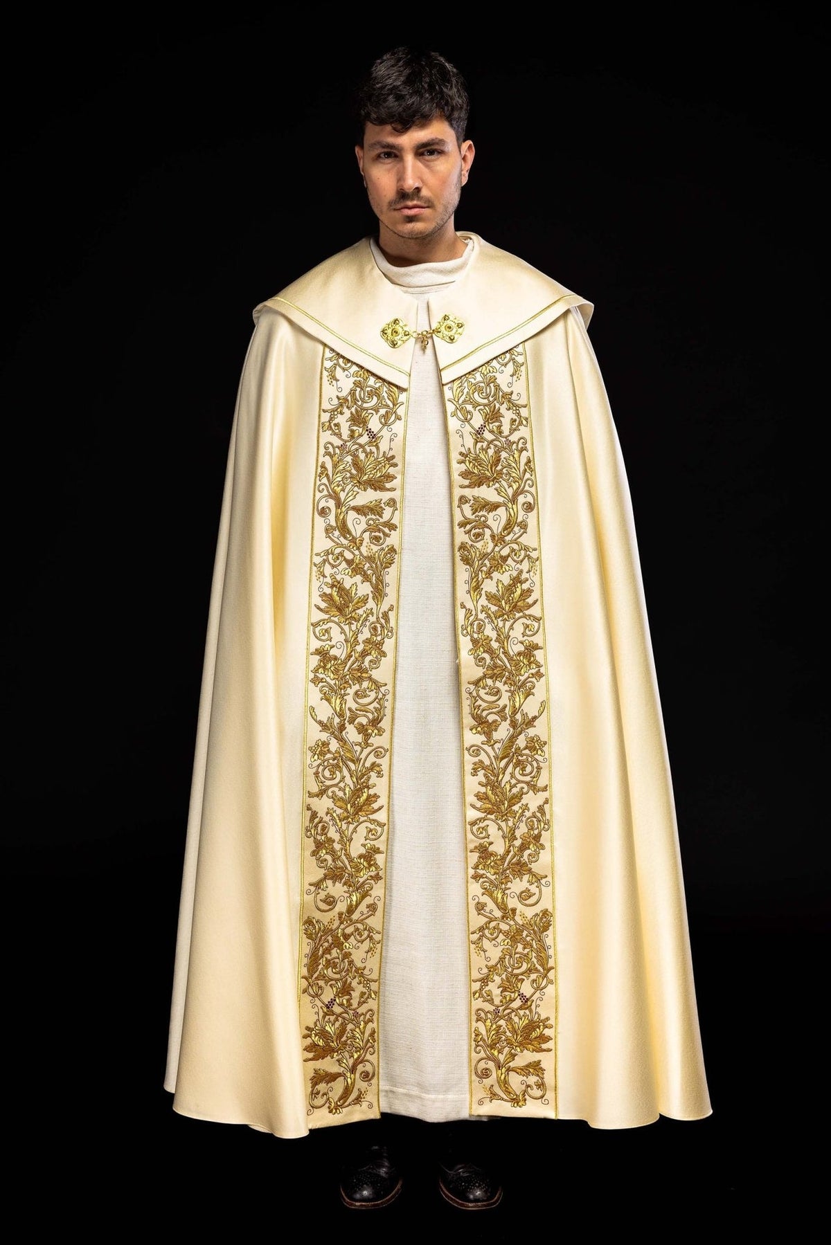 Ecru cope front view with ornate gold floral embroidery and decorative clasp