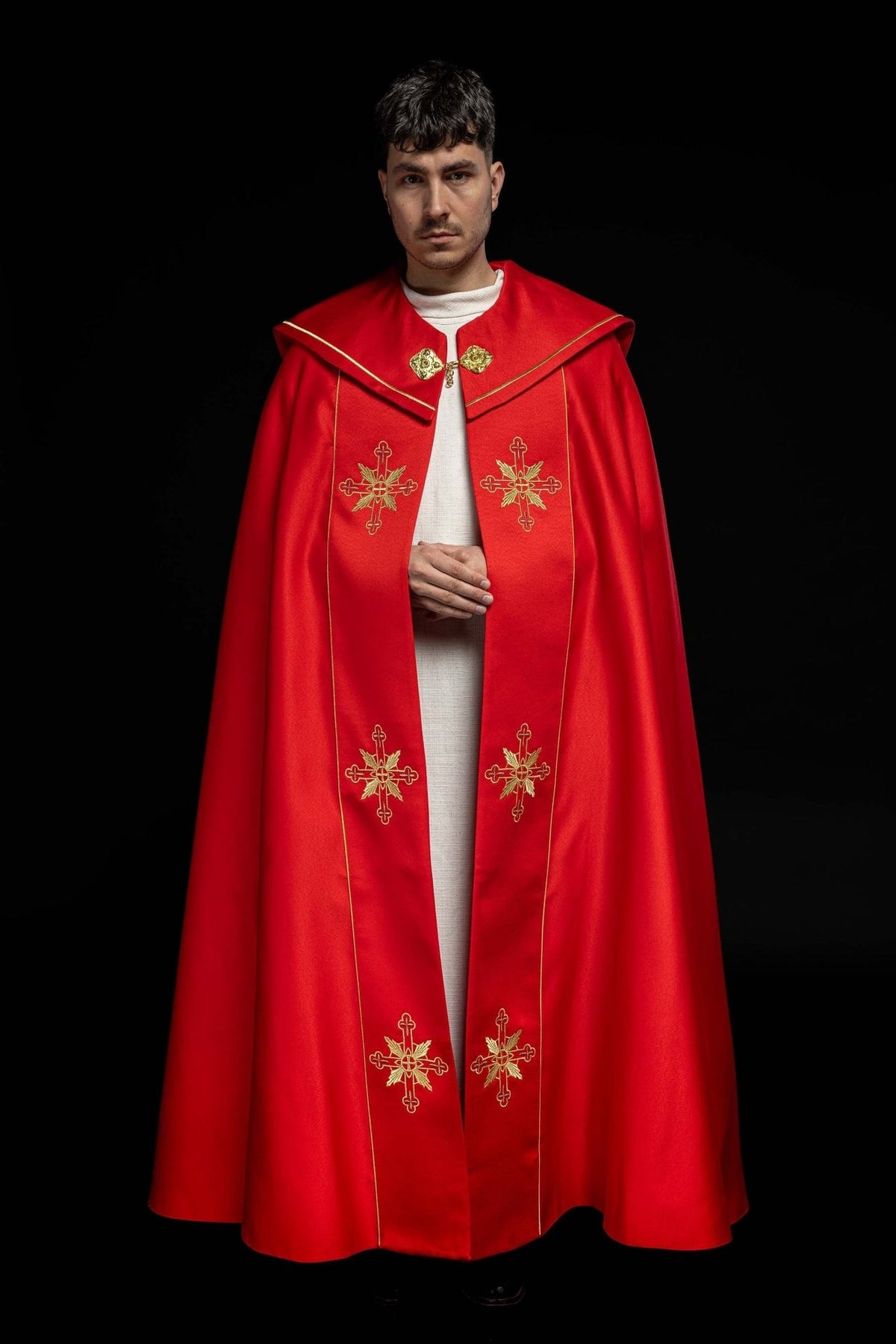 Red cope, front view with gold cross embroidery and satin trim
