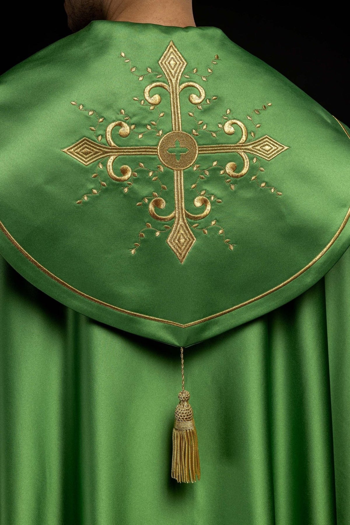 Green cope back close-up with large gold embroidered cross and tassel