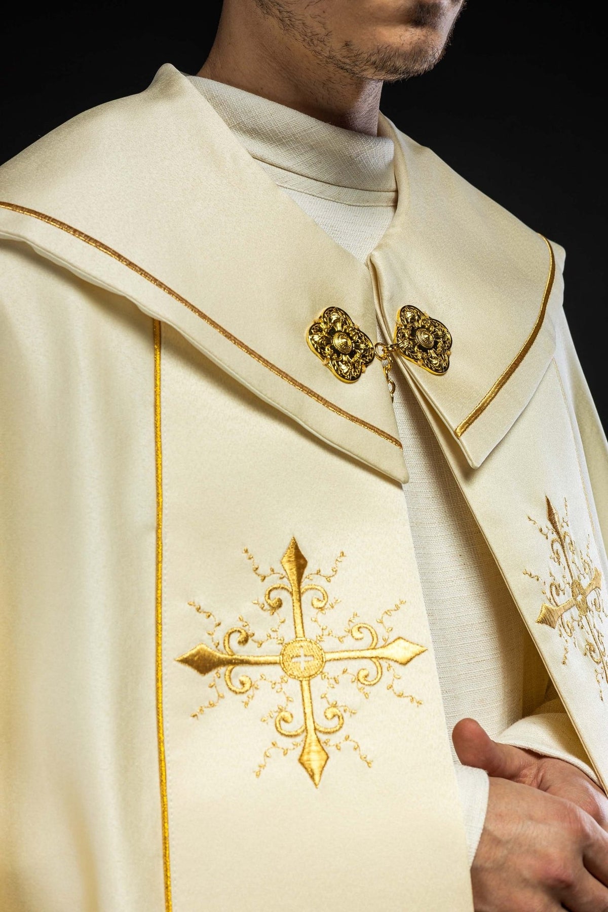 Ecru cope, close-up of gold-trimmed collar and ornate fastening