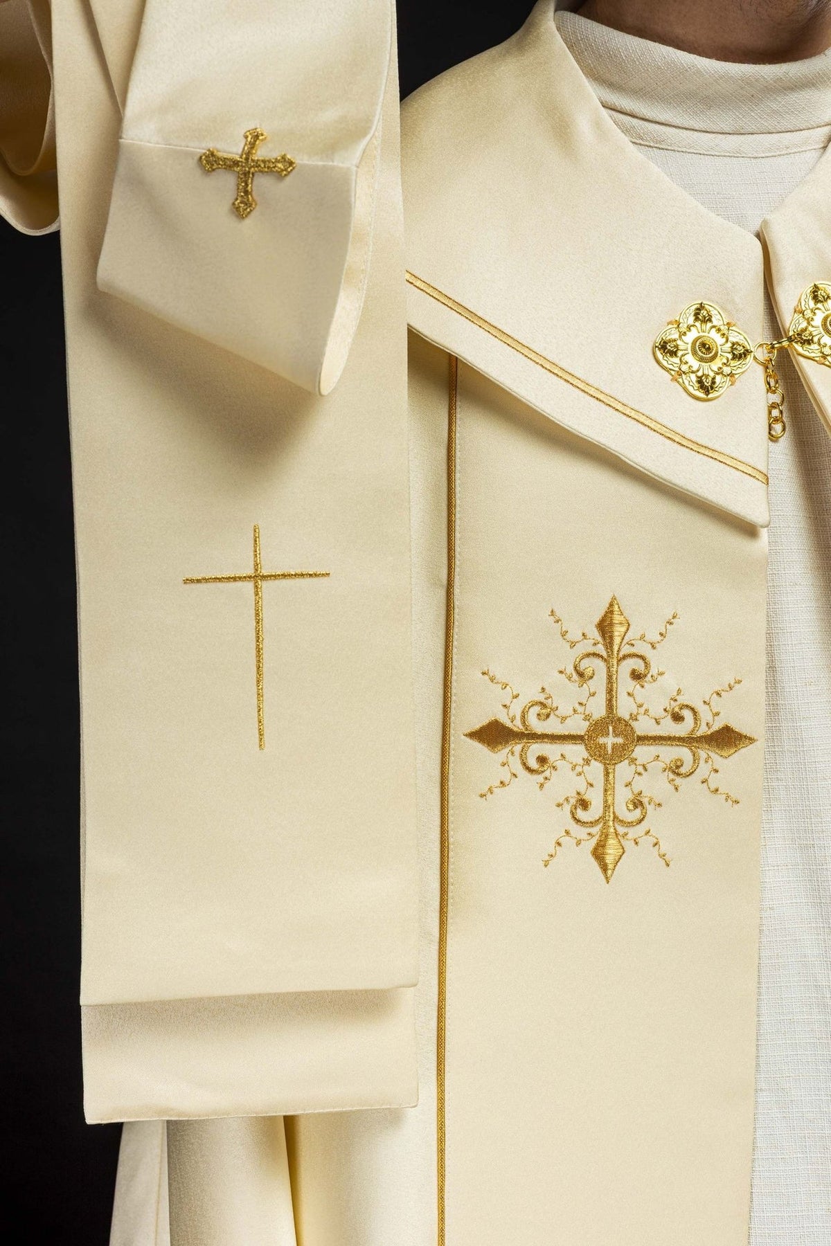 Ecru cope, close-up of embroidered gold cross and collar fastening