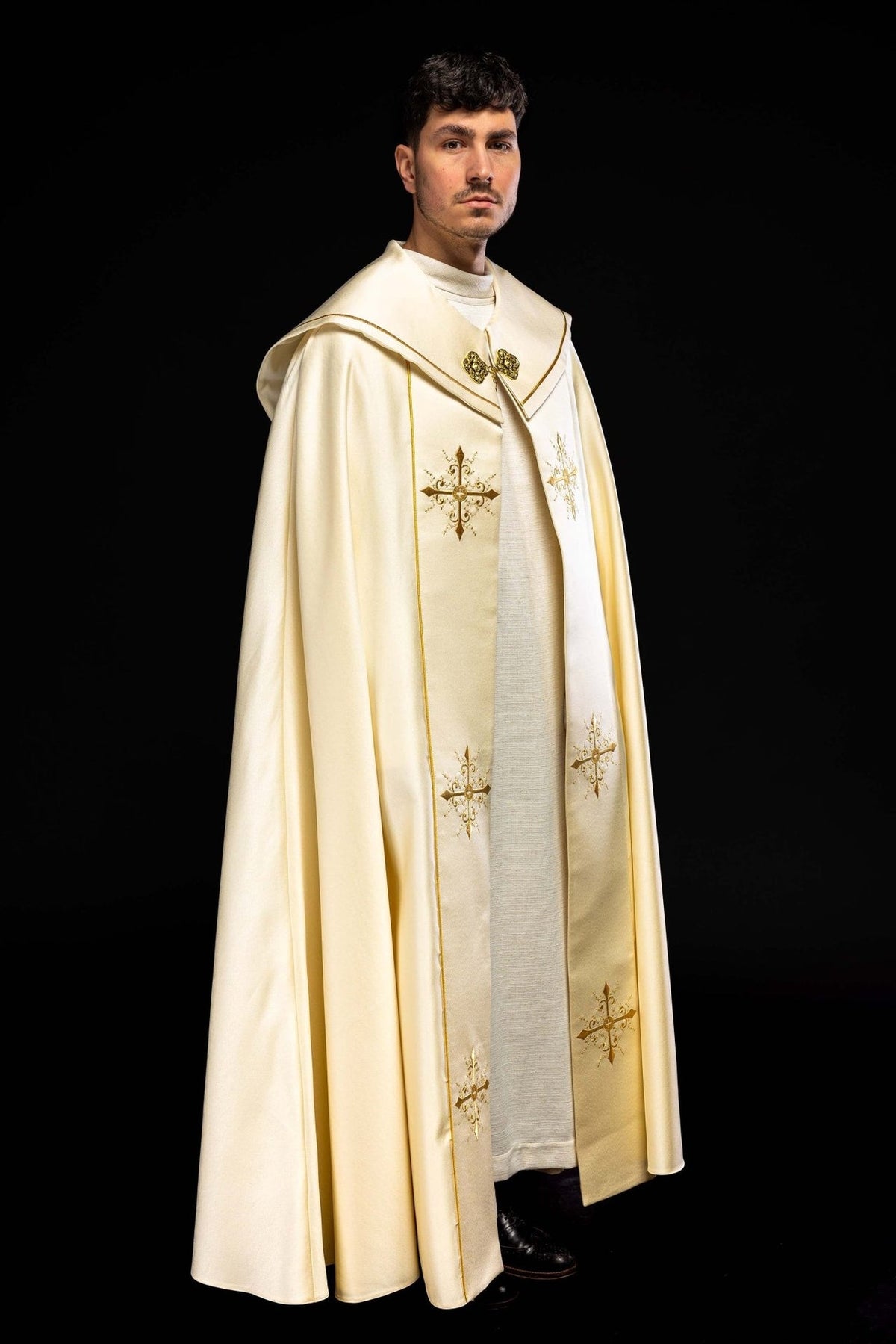 Ecru cope, full back view with flowing fabric and embroidered cross