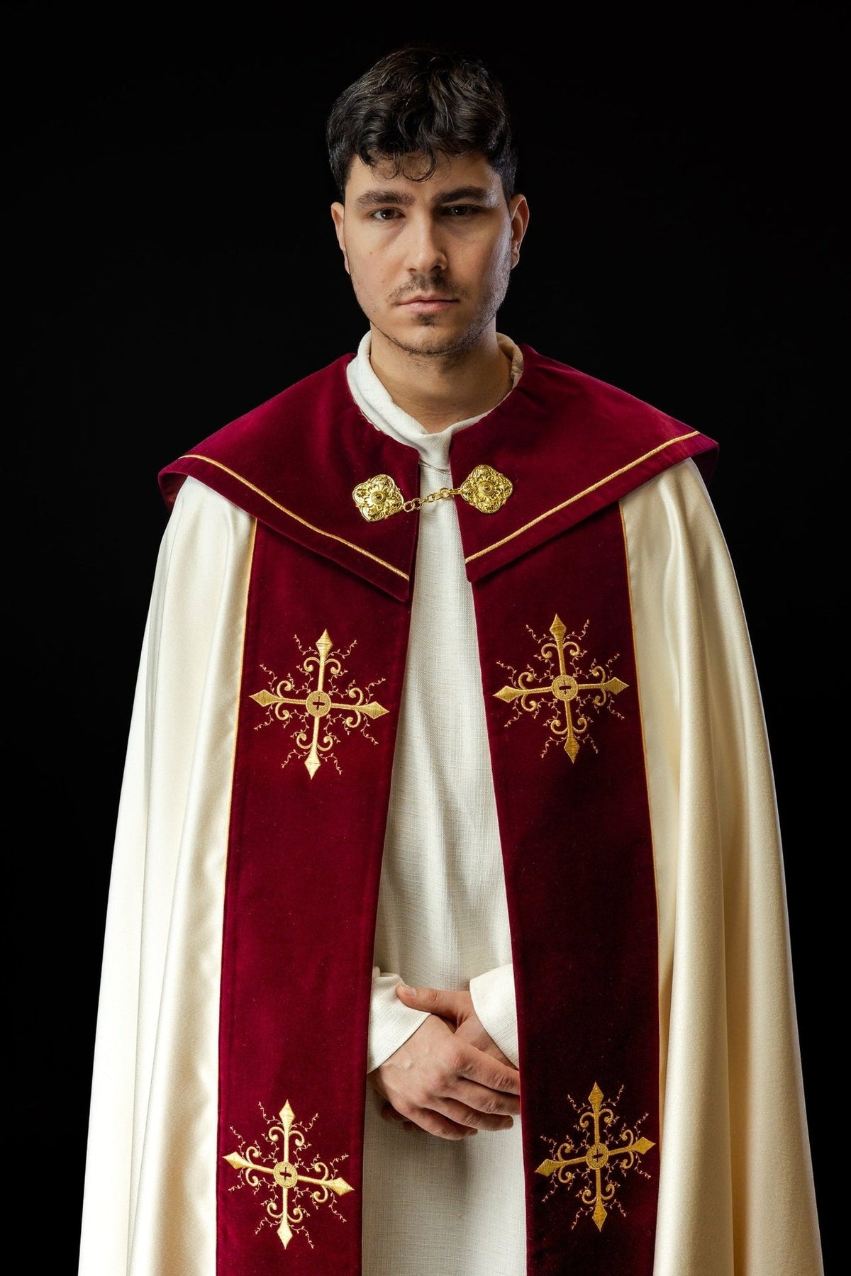 Burgundy velvet cope front close-up with gold cross embroidery and clasp