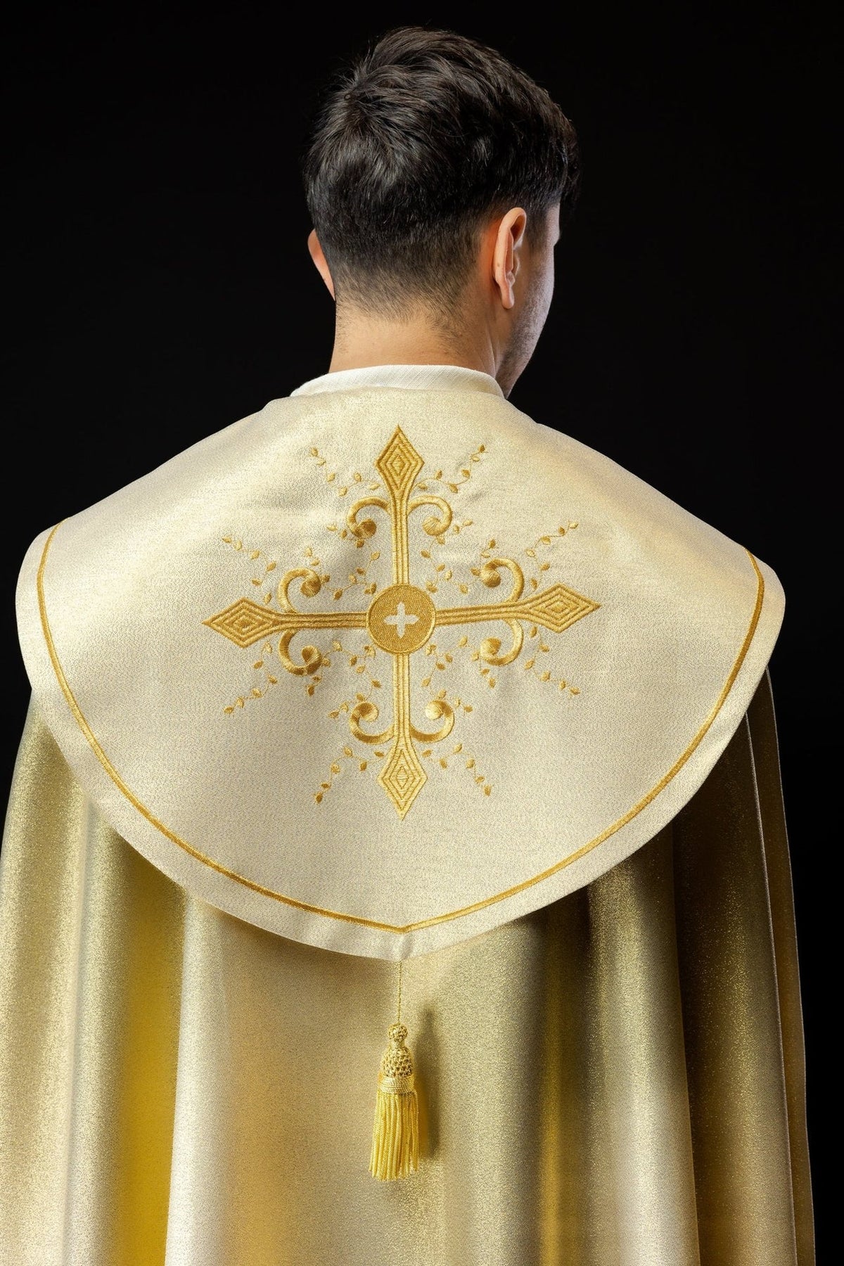 Gold cope back view with large embroidered cross, gold edging and tassel