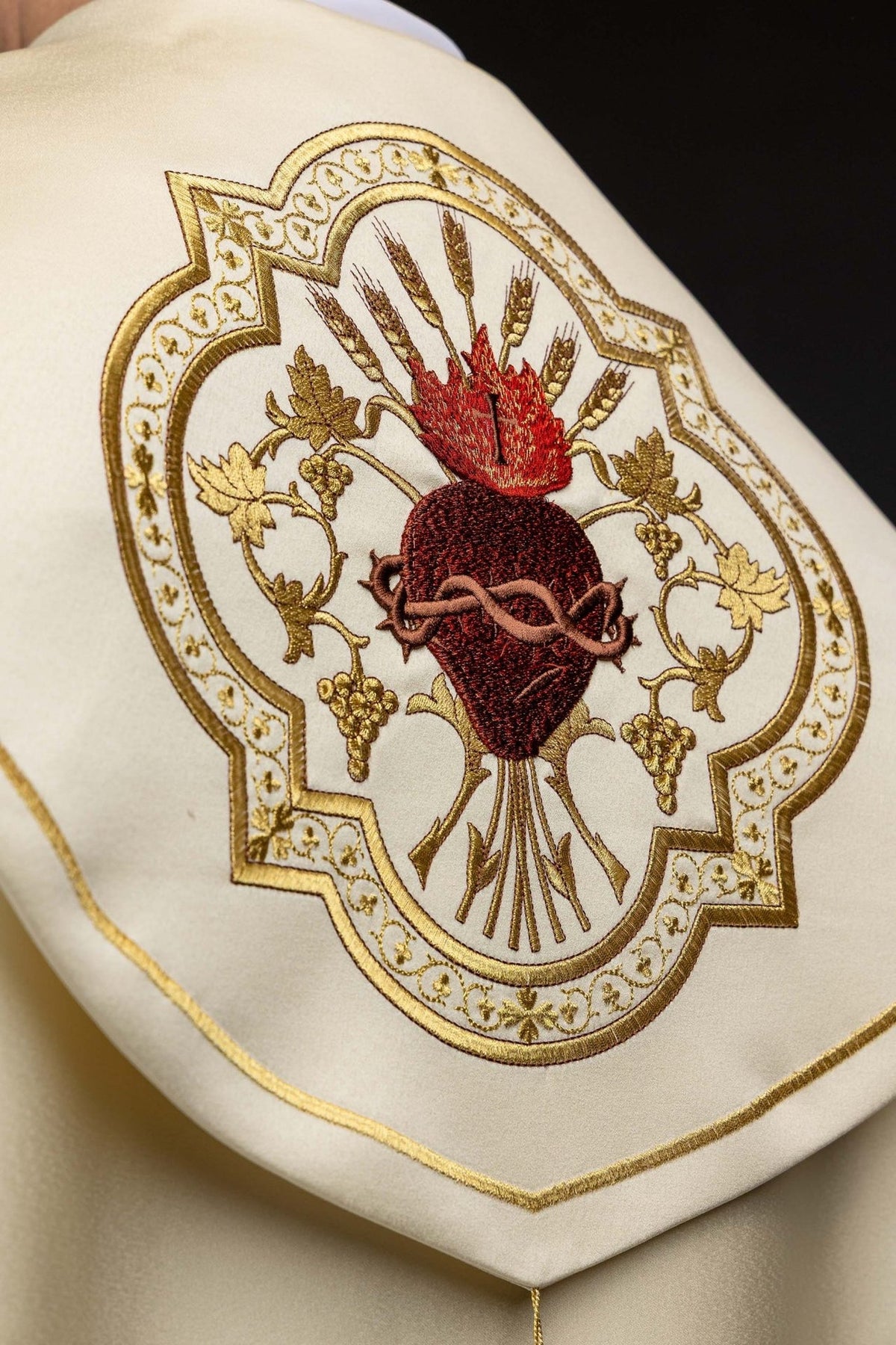 Ecru cope close-up of Sacred Heart of Jesus embroidery