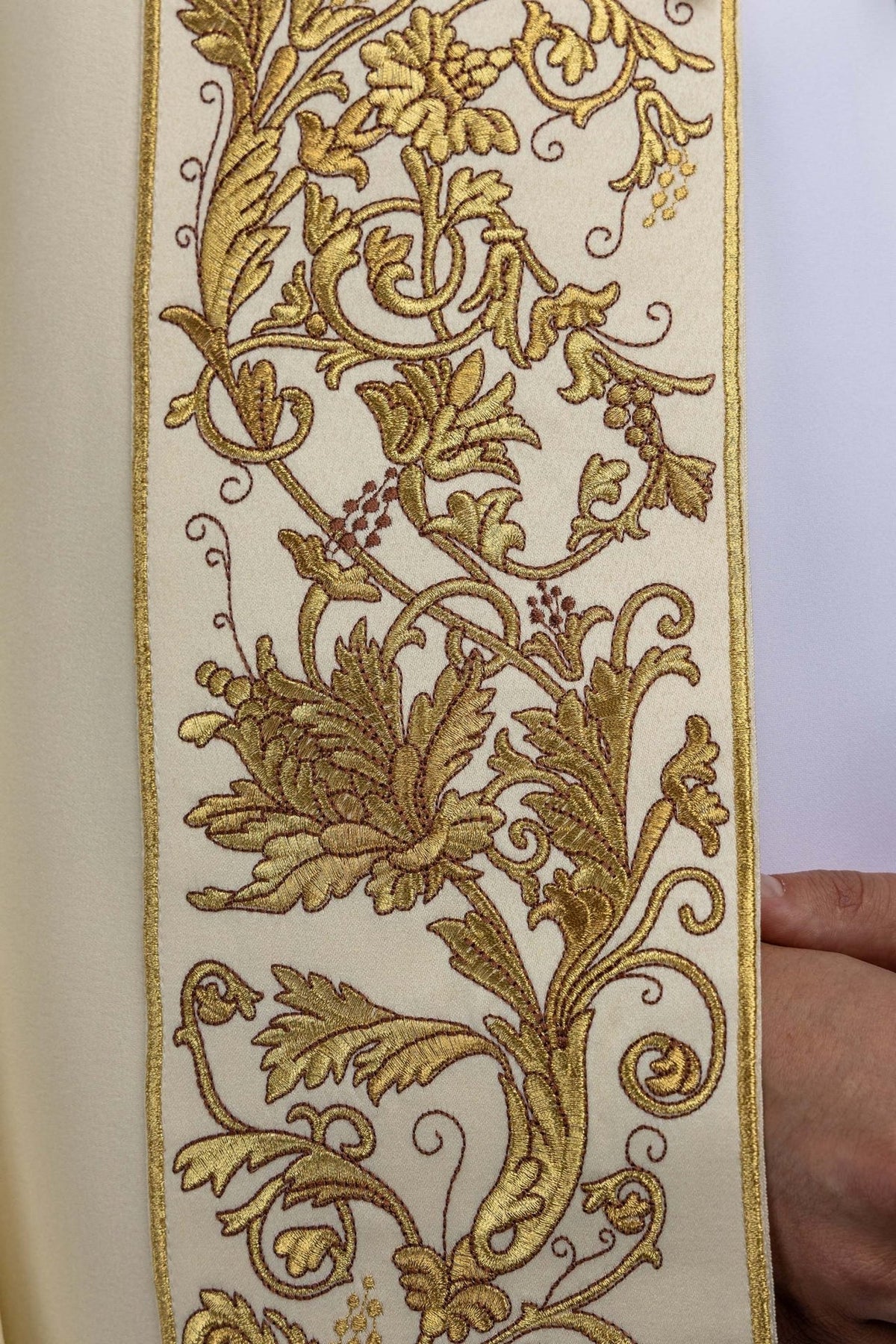 Ecru cope detail of gold floral and leaf embroidery