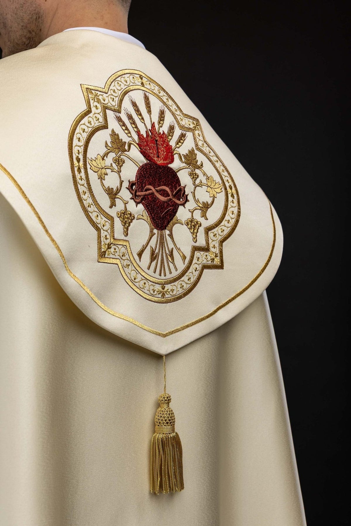 Ecru cope back view with Sacred Heart of Jesus embroidery and gold tassel