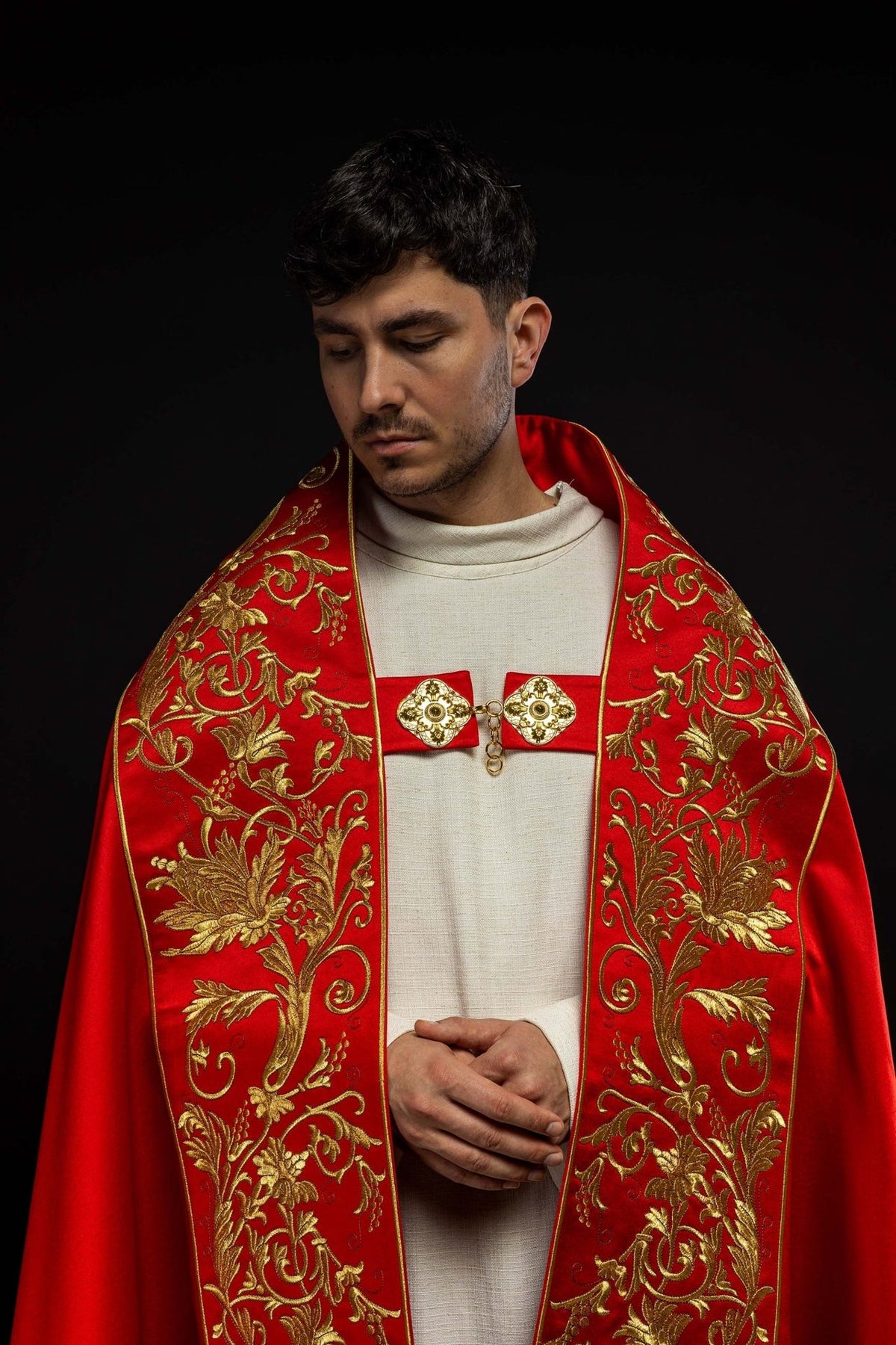 Red satin cope, front close-up showing gold floral embroidery and clasp