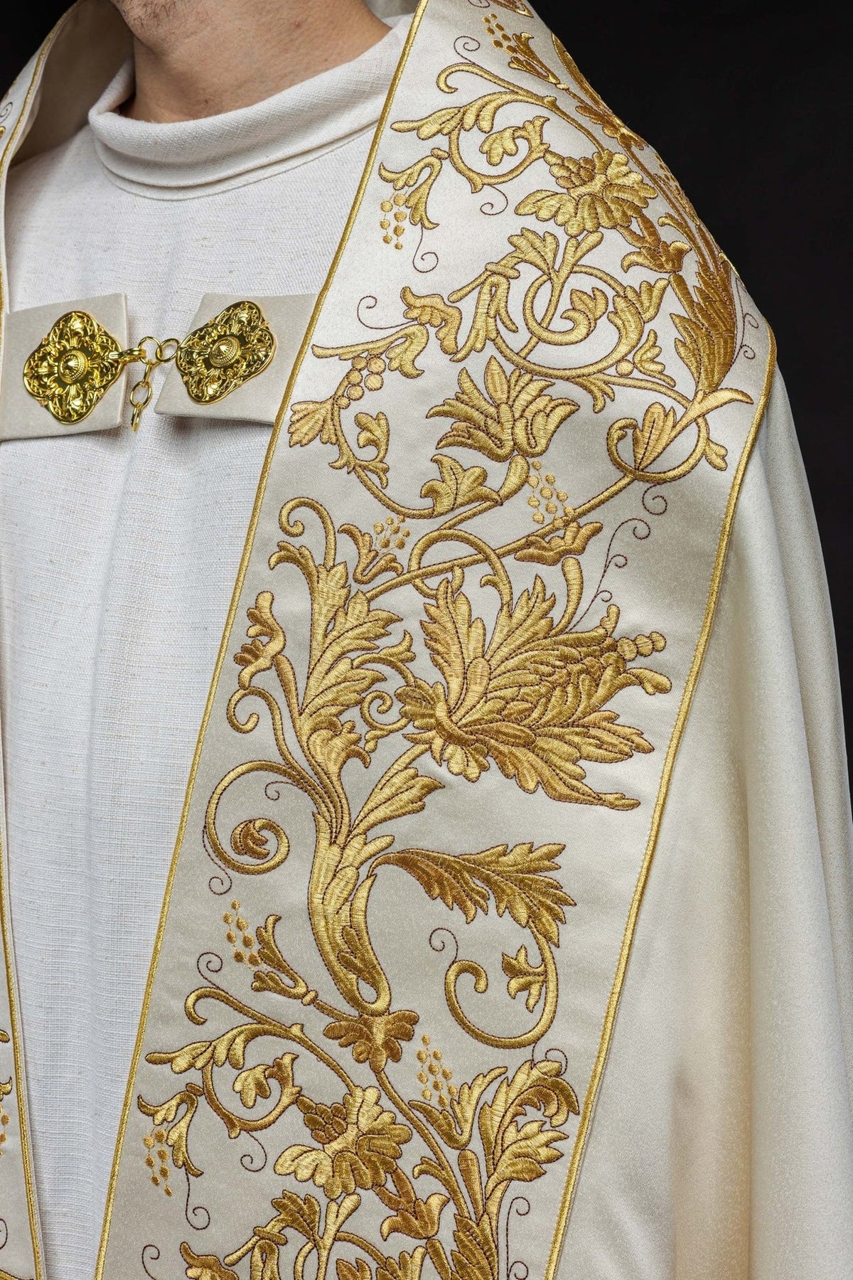 Ecru satin cope, close-up of gold floral embroidery and clasp
