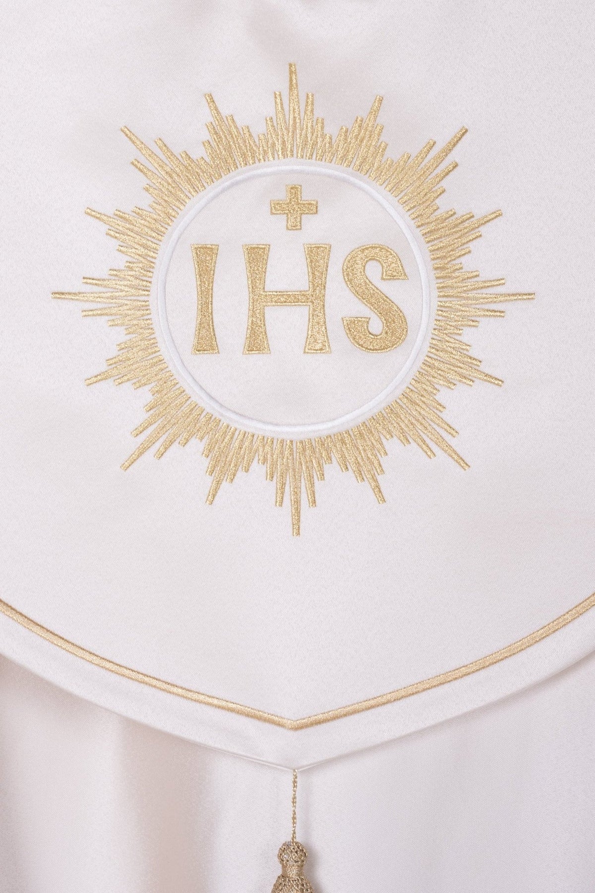 Ecru cope close-up of gold IHS sunburst embroidery and trimmed collar