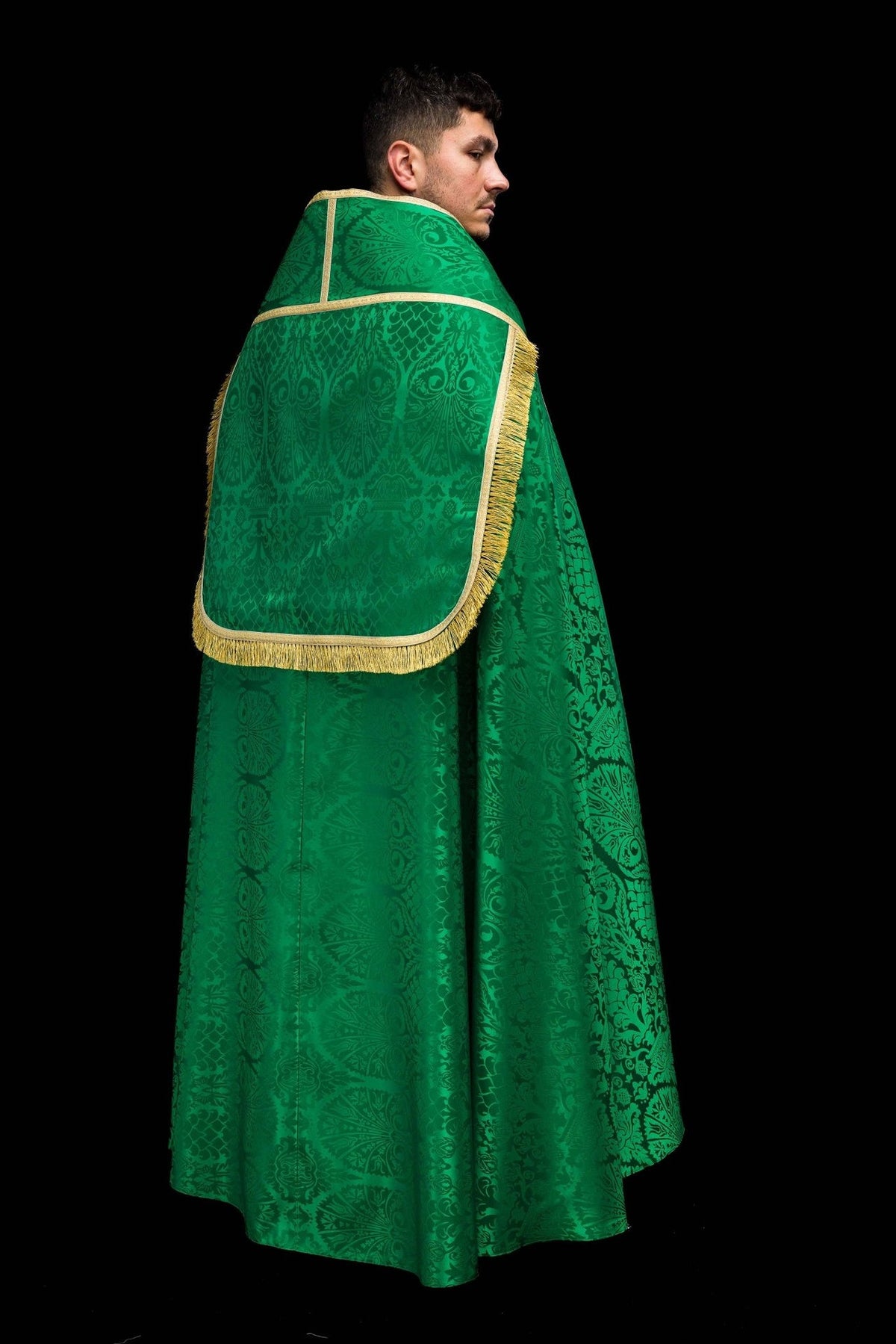 Green jacquard cope back detail showing gold trim across the shoulders and woven motifs