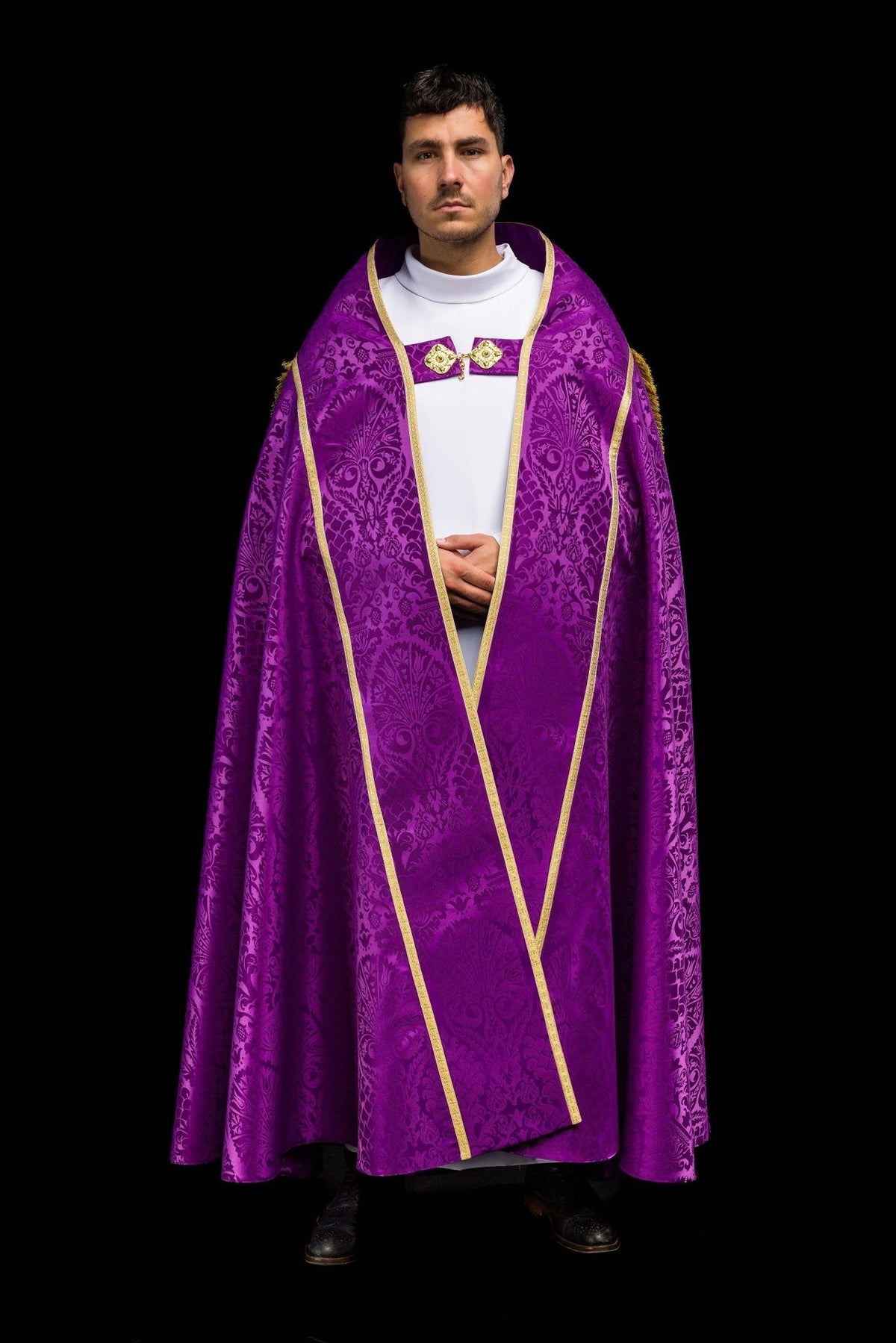 Purple cope worn full front view with ornate jacquard pattern and gold edging