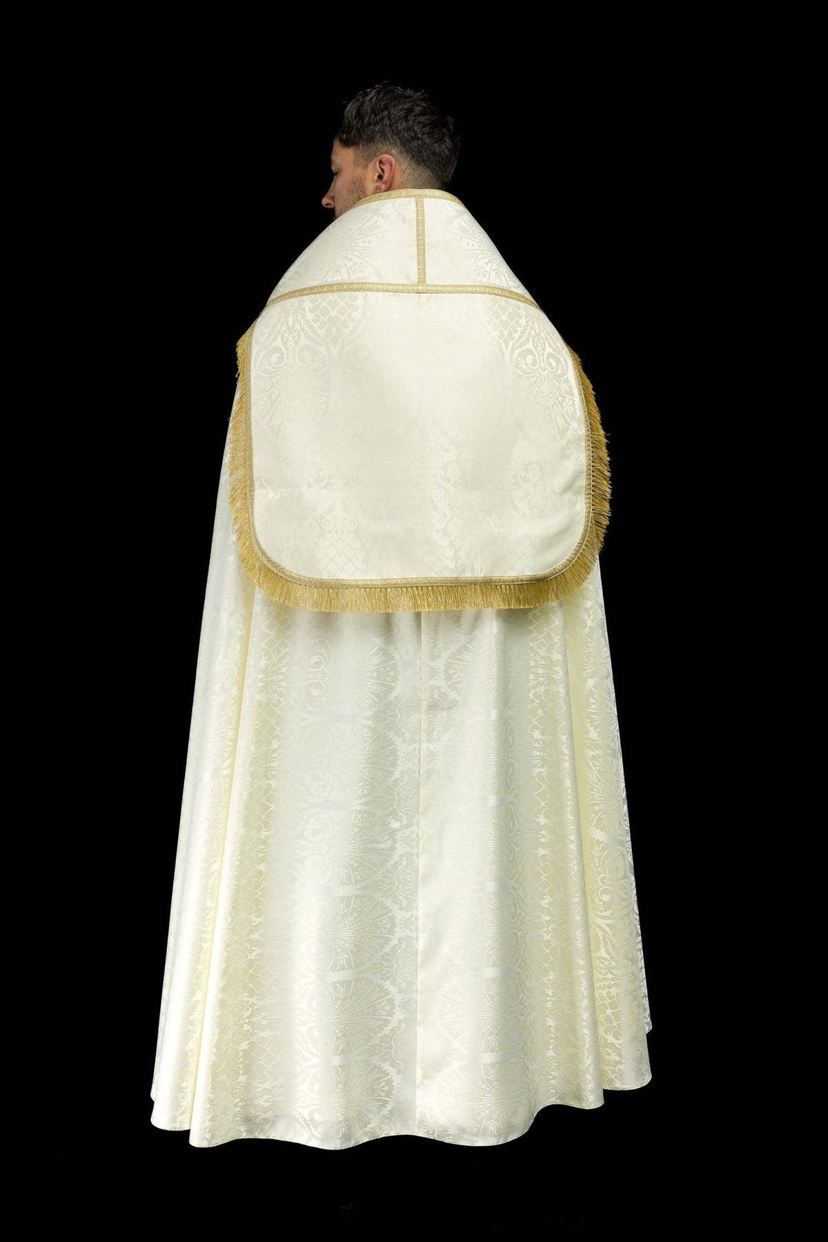 Roman cope full back view in ecru jacquard with gold trim and fringe