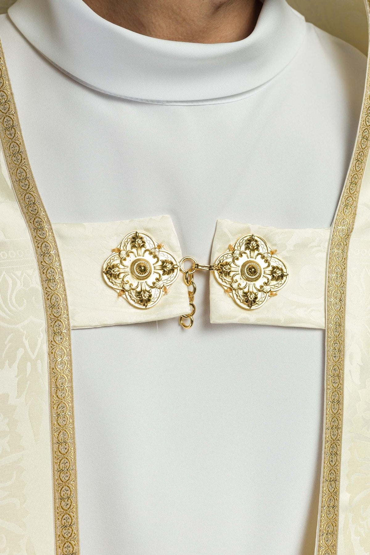 Roman cope close-up showing gold floral clasp and jacquard border