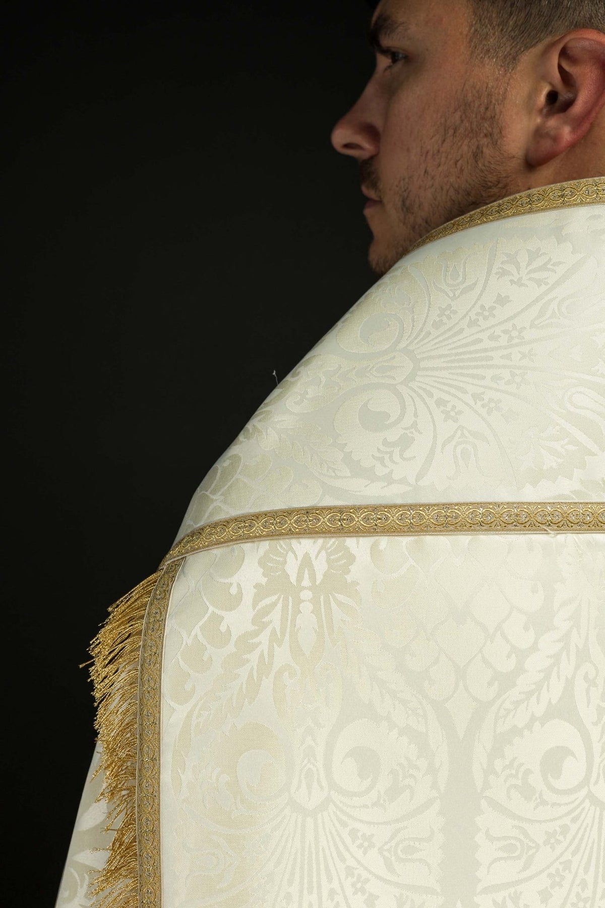 Roman cope side close-up showing ecru jacquard, gold border and fringe