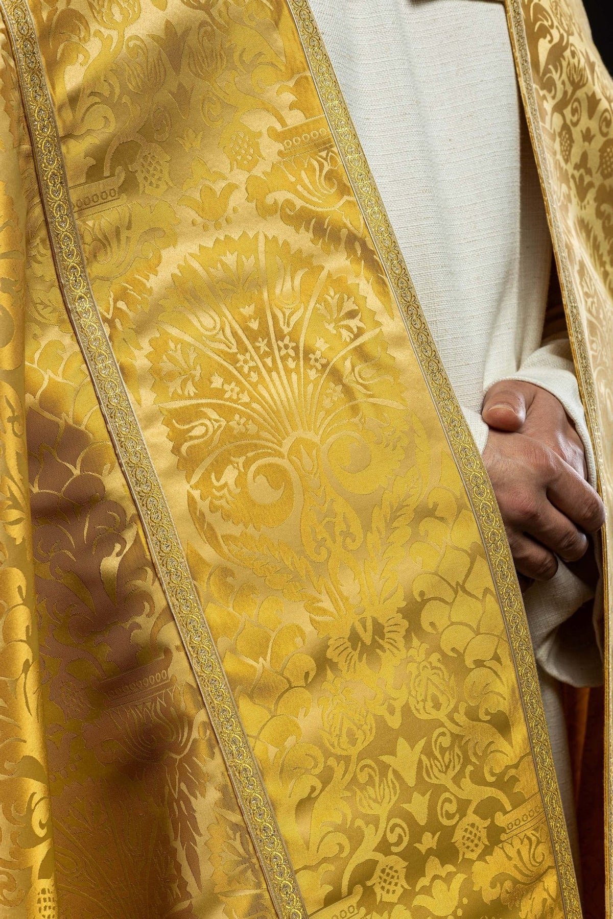 Gold cope front panel close-up with floral jacquard fabric and patterned gold edging