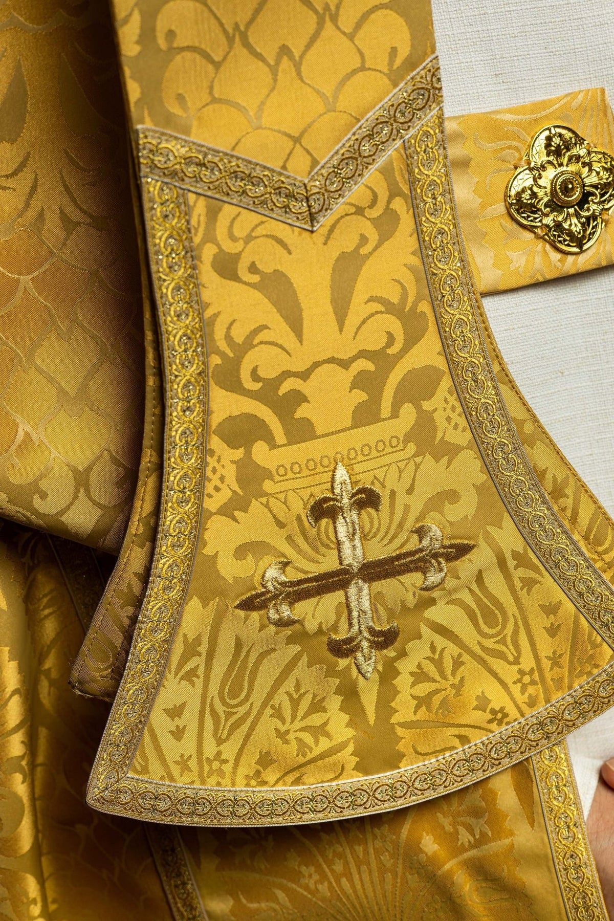 Gold cope embroidered cross detail with floral jacquard fabric and decorative border