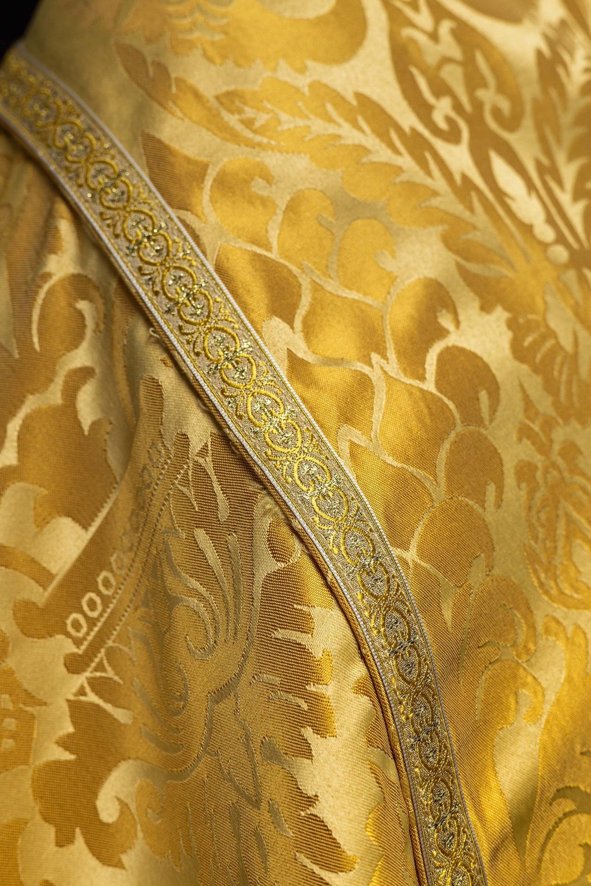 Gold cope jacquard fabric and ornate gold edging close-up