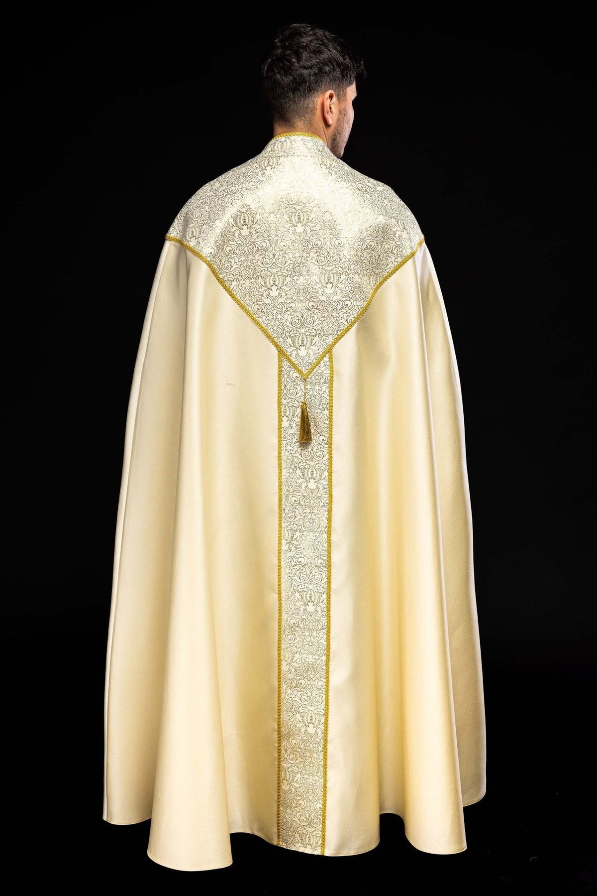 Ecru cope back view with patterned jacquard yoke and central embroidered panel