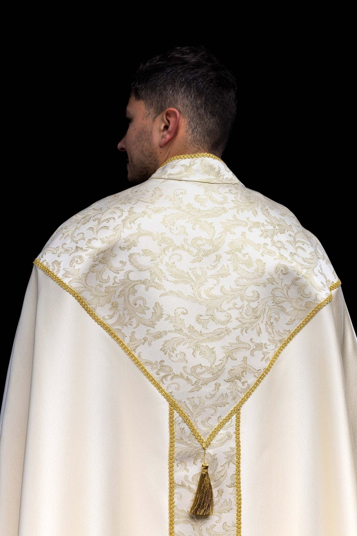 Ecru cope back view with jacquard fabric decoration, central panel and gold tassel