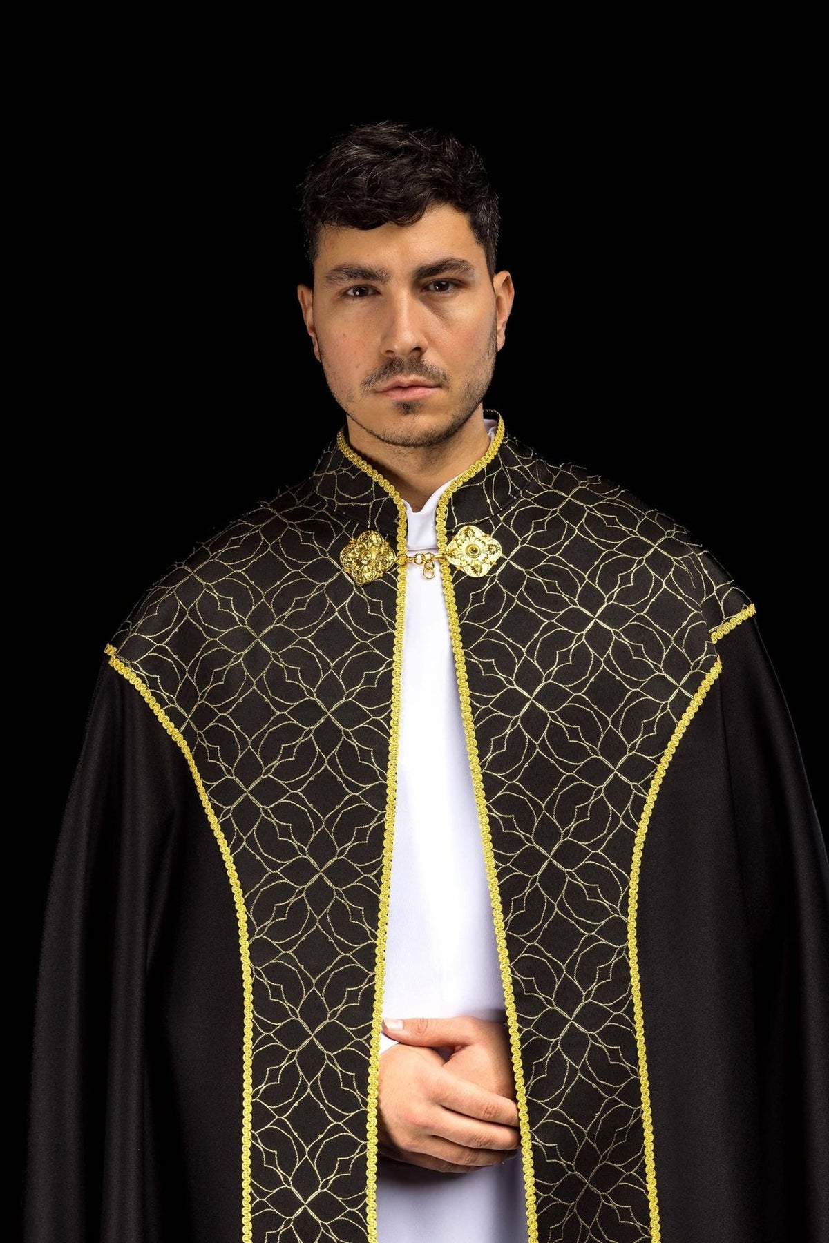 Black cope front close-up with gold floral embroidery, trim and ornate clasp