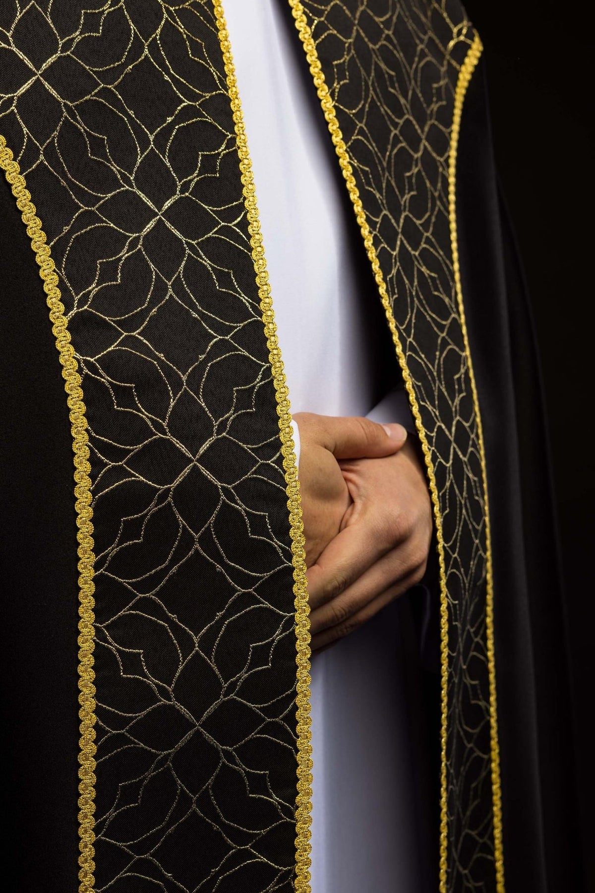 Black cope front detail showing gold floral embroidery and trim