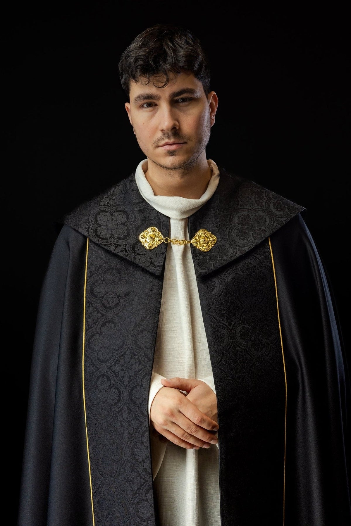 Black cope worn from the front with jacquard panels and gold clasp