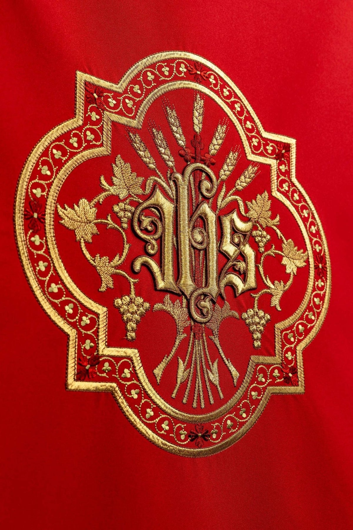 Church lectern cover close-up showing detailed gold JHS embroidery