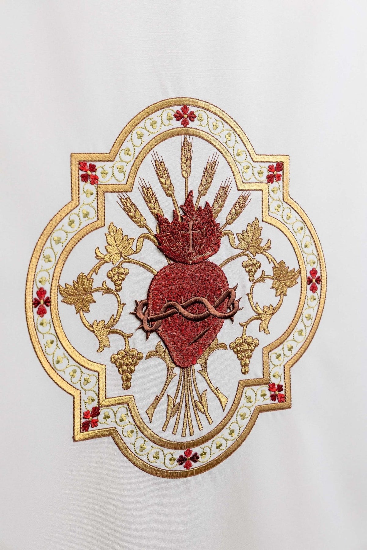 Church lectern cover close-up showing Sacred Heart of Jesus with gold wheat and grape embroidery
