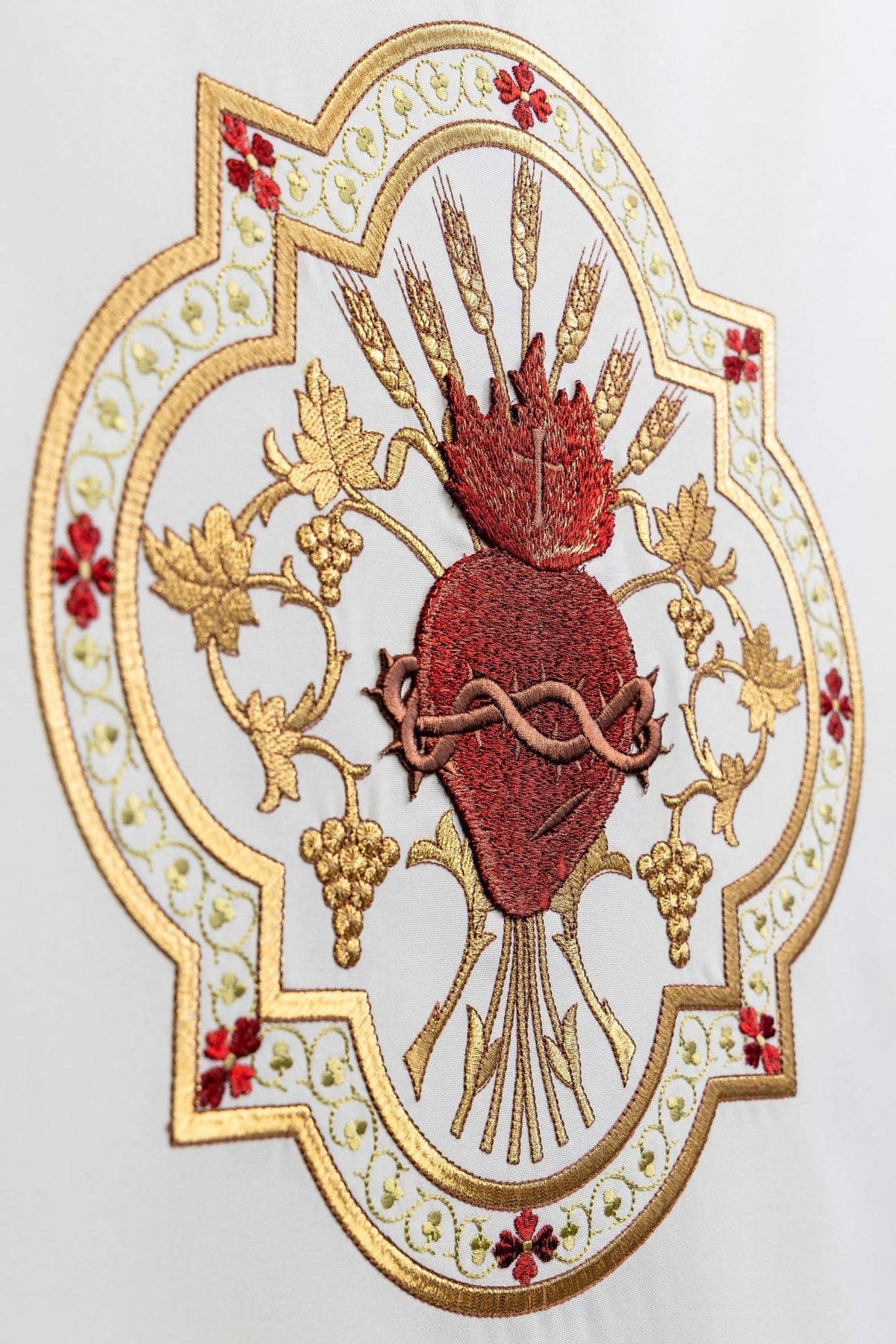 Church lectern cover close-up of Sacred Heart of Jesus surrounded by ornate gold and red embroidery