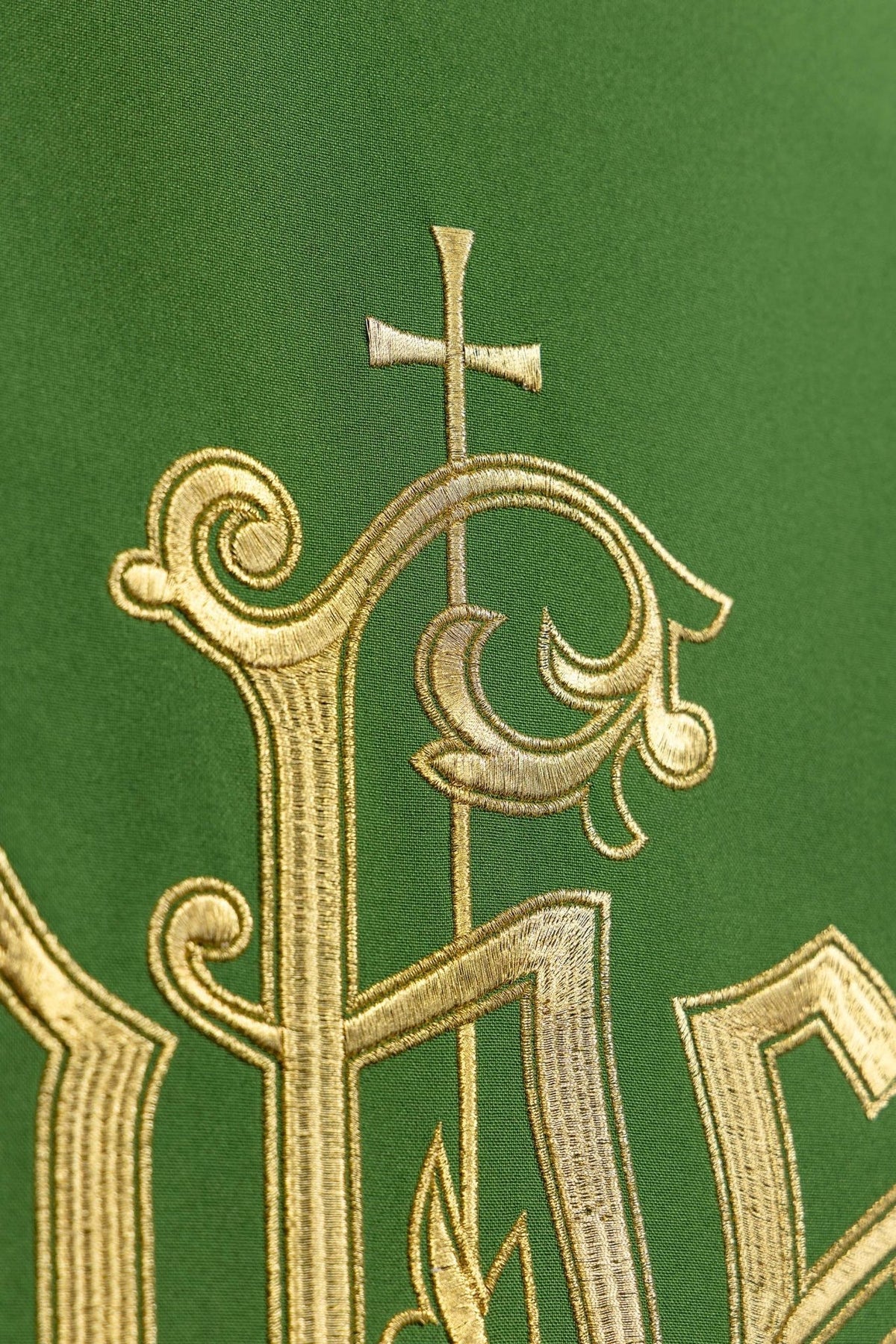 Green church lectern cover detail of gold embroidered cross and IHS lettering