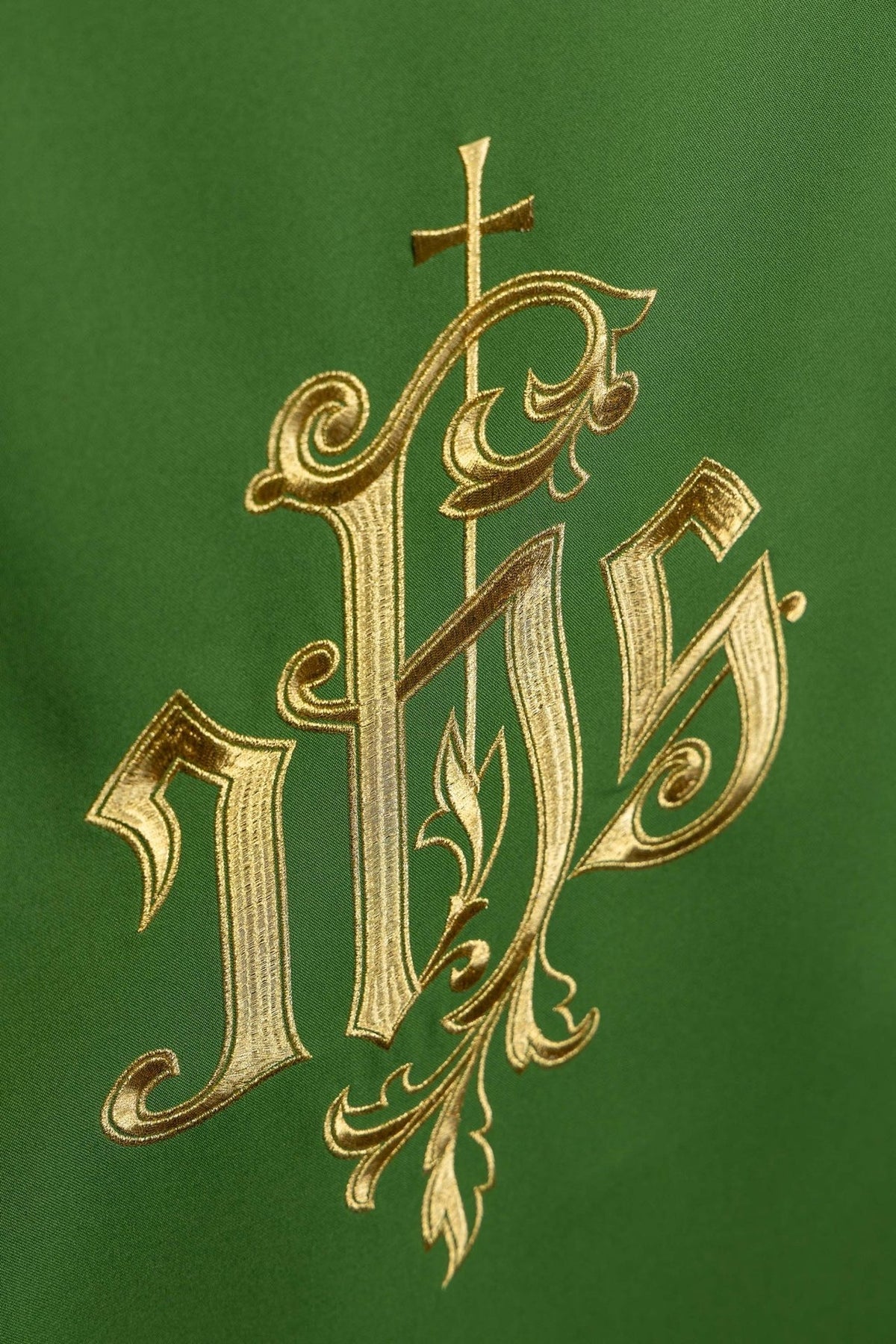 Green church lectern cover angled close-up of gold IHS embroidery and cross