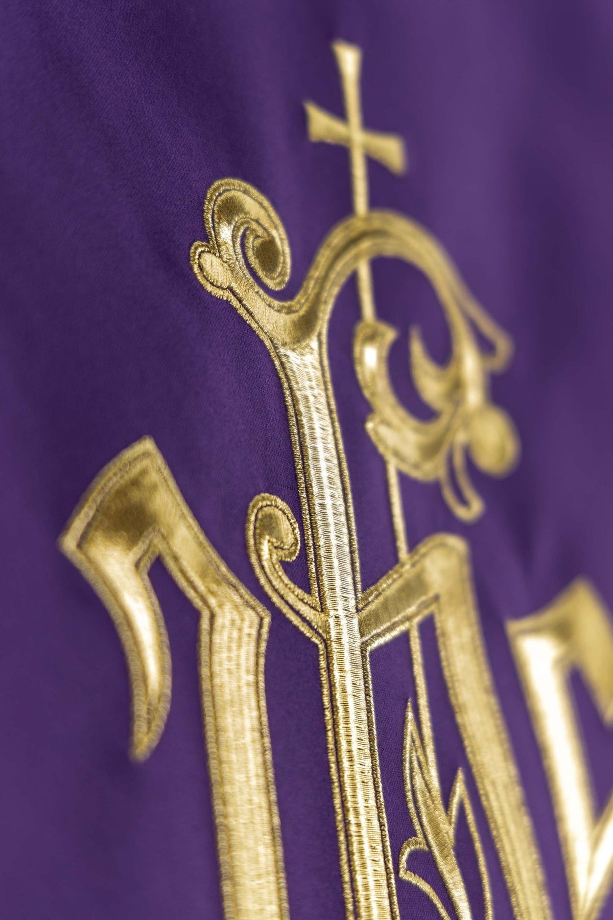 Purple church lectern cover close-up of the gold cross and IHS embroidery