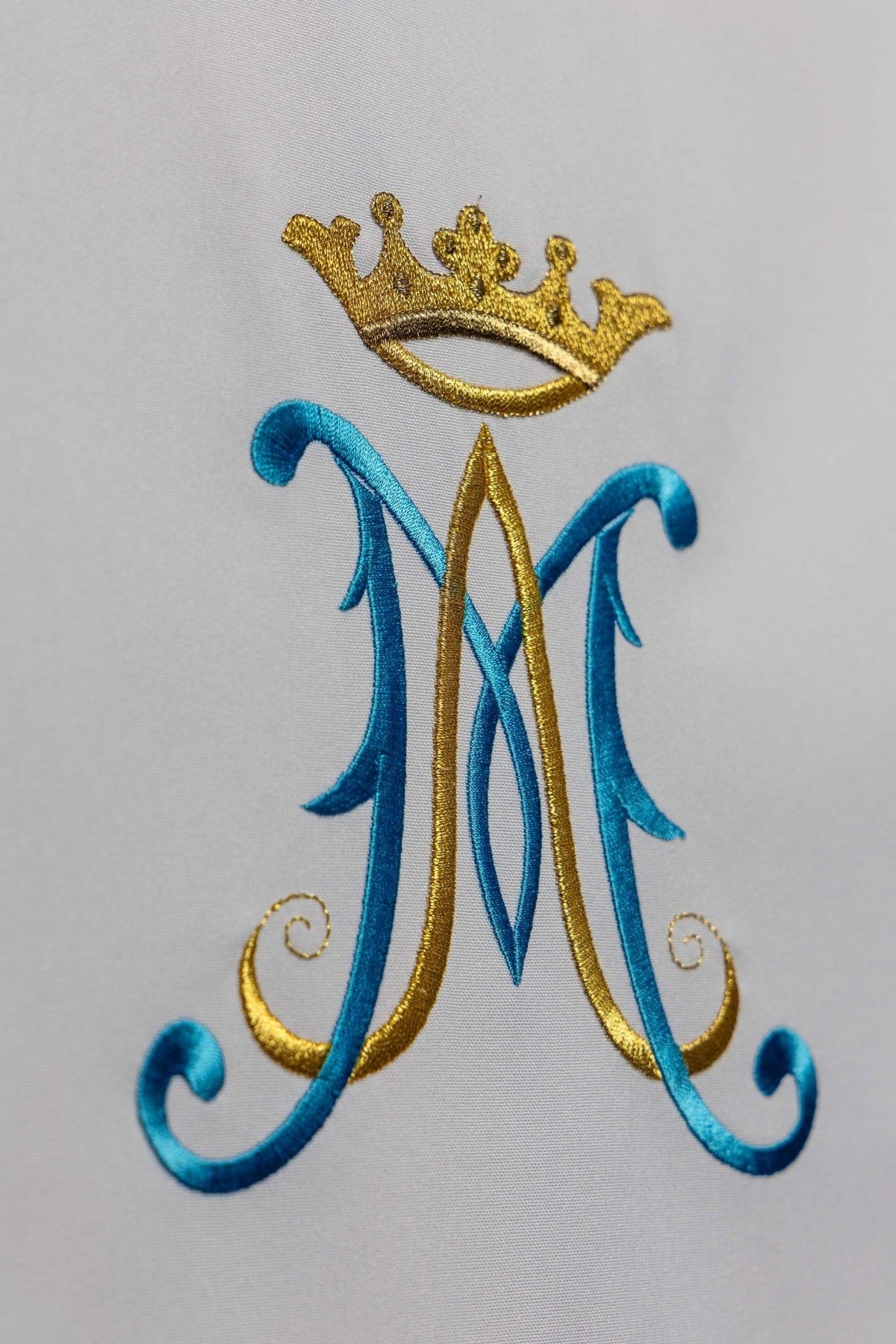 Church lectern cover close-up of crowned blue Marian monogram embroidery