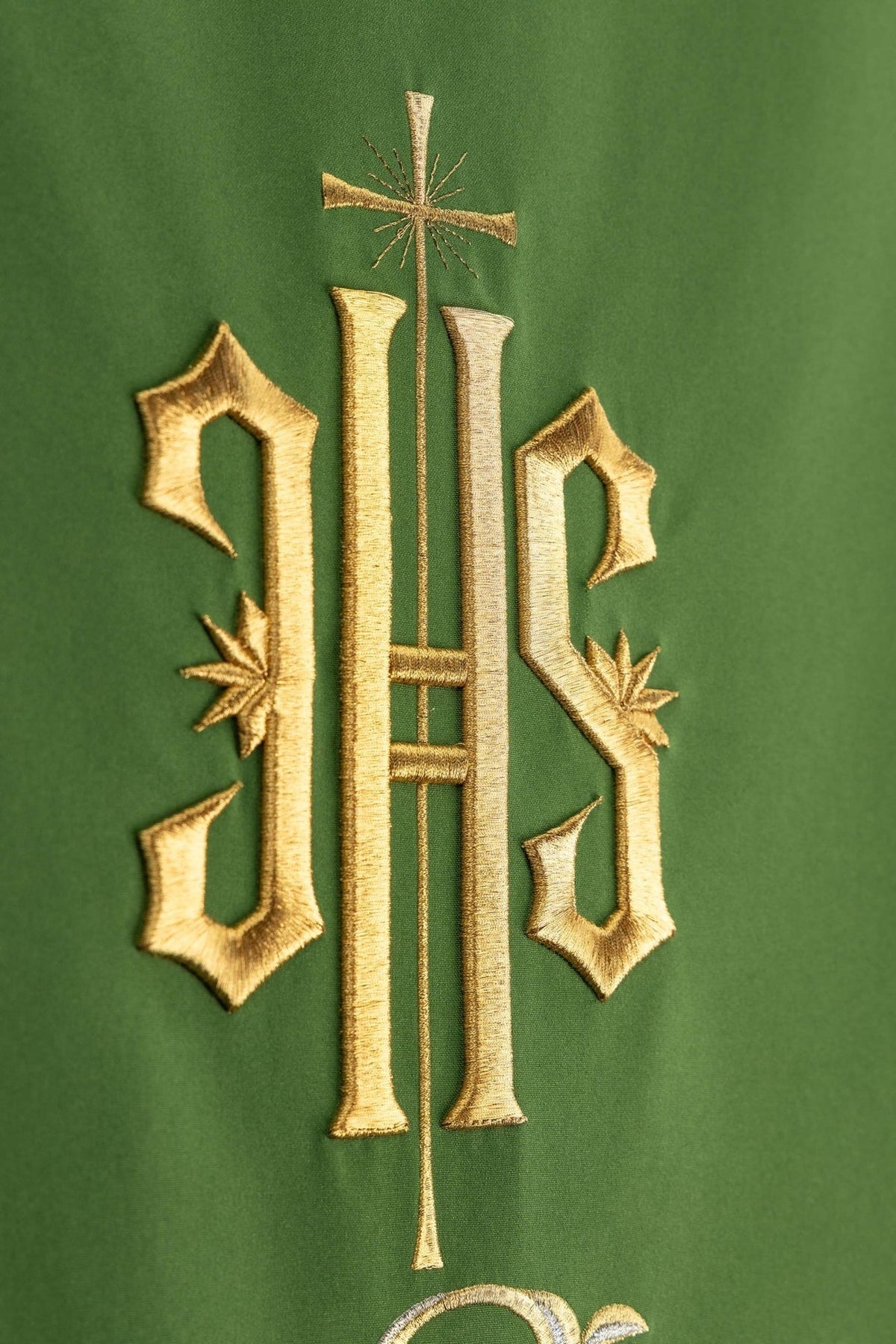 Church lectern cover close-up with gold embroidered IHS monogram and cross