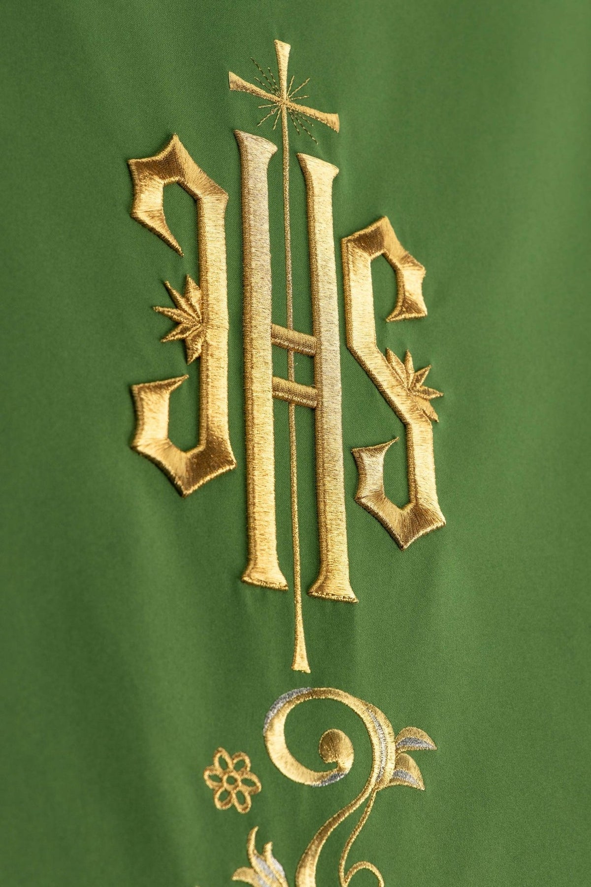 Church lectern cover detail with embroidered IHS monogram and botanical ornament